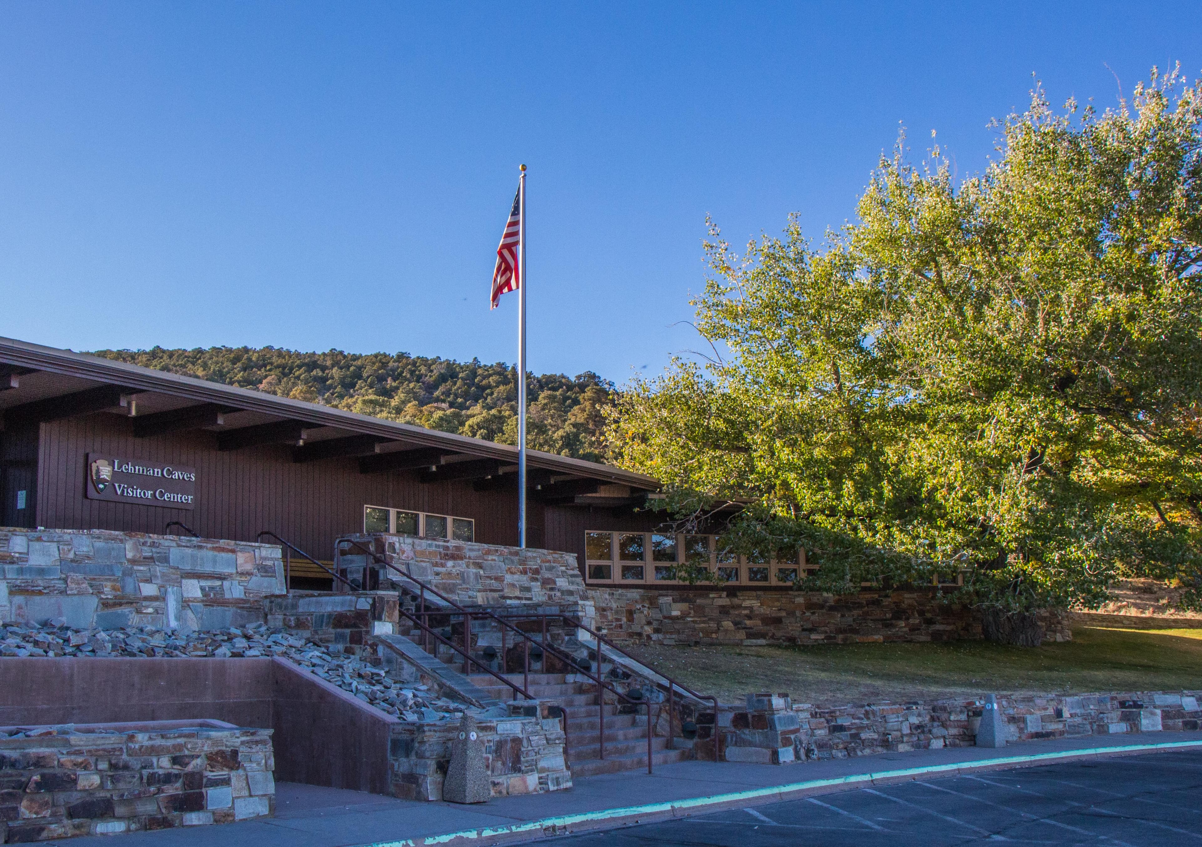 Brown Visitor Center with big green tress to the right