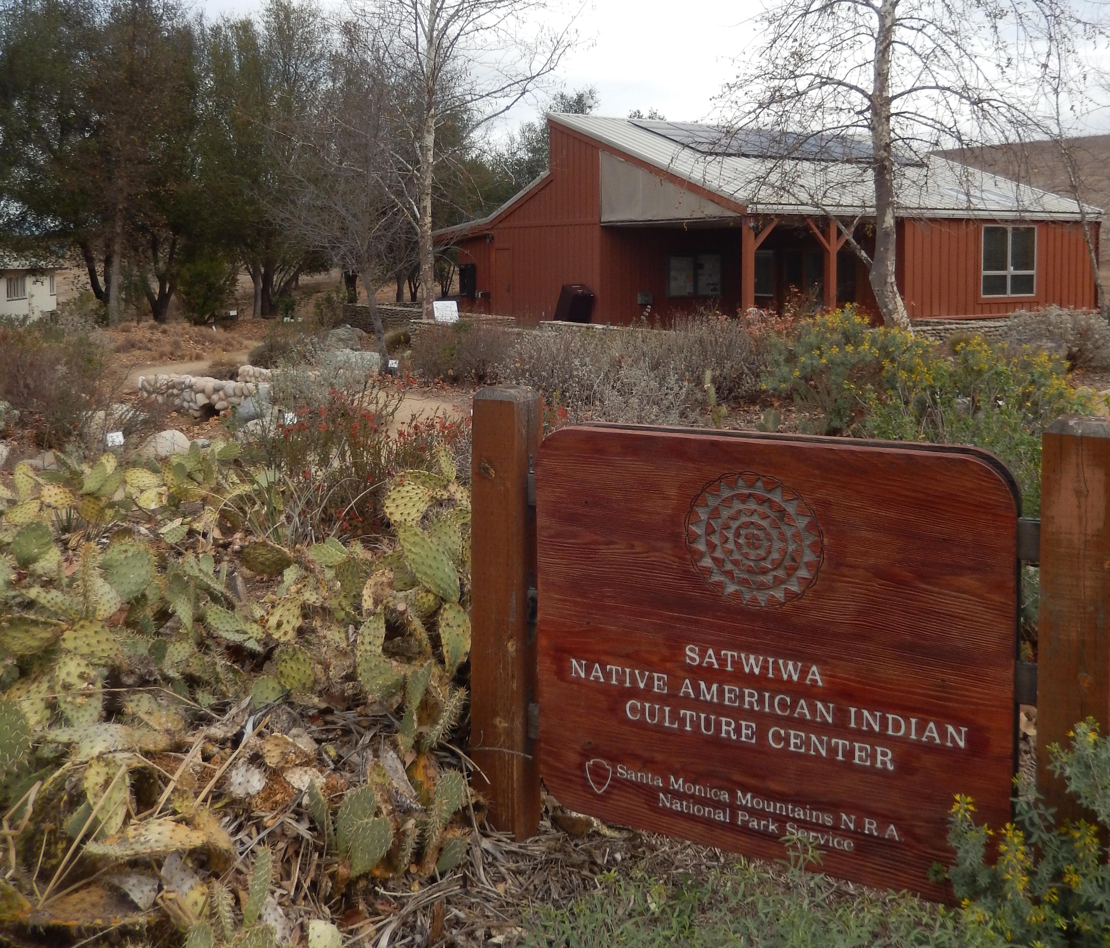 Brown sign among cacti in from of Satwiwa Native American Indian Culture Center
