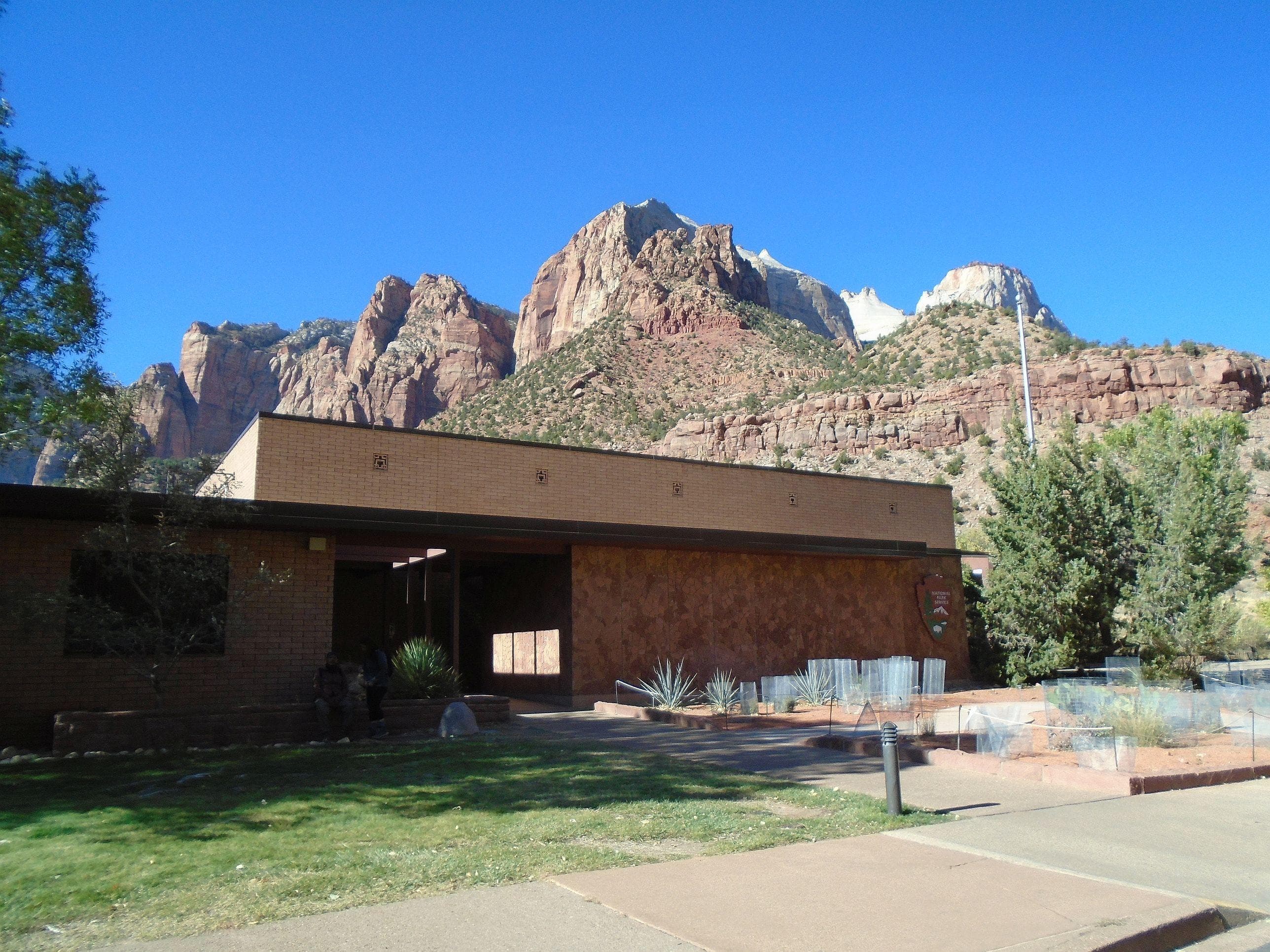 A brick building with mountains in the background