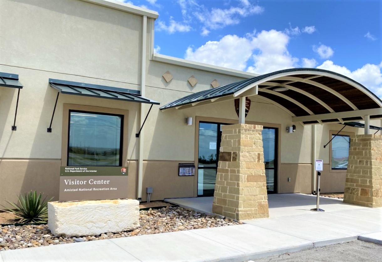 Close-up view of front face of Visitor Center with walkways and outdoor brochure holder.