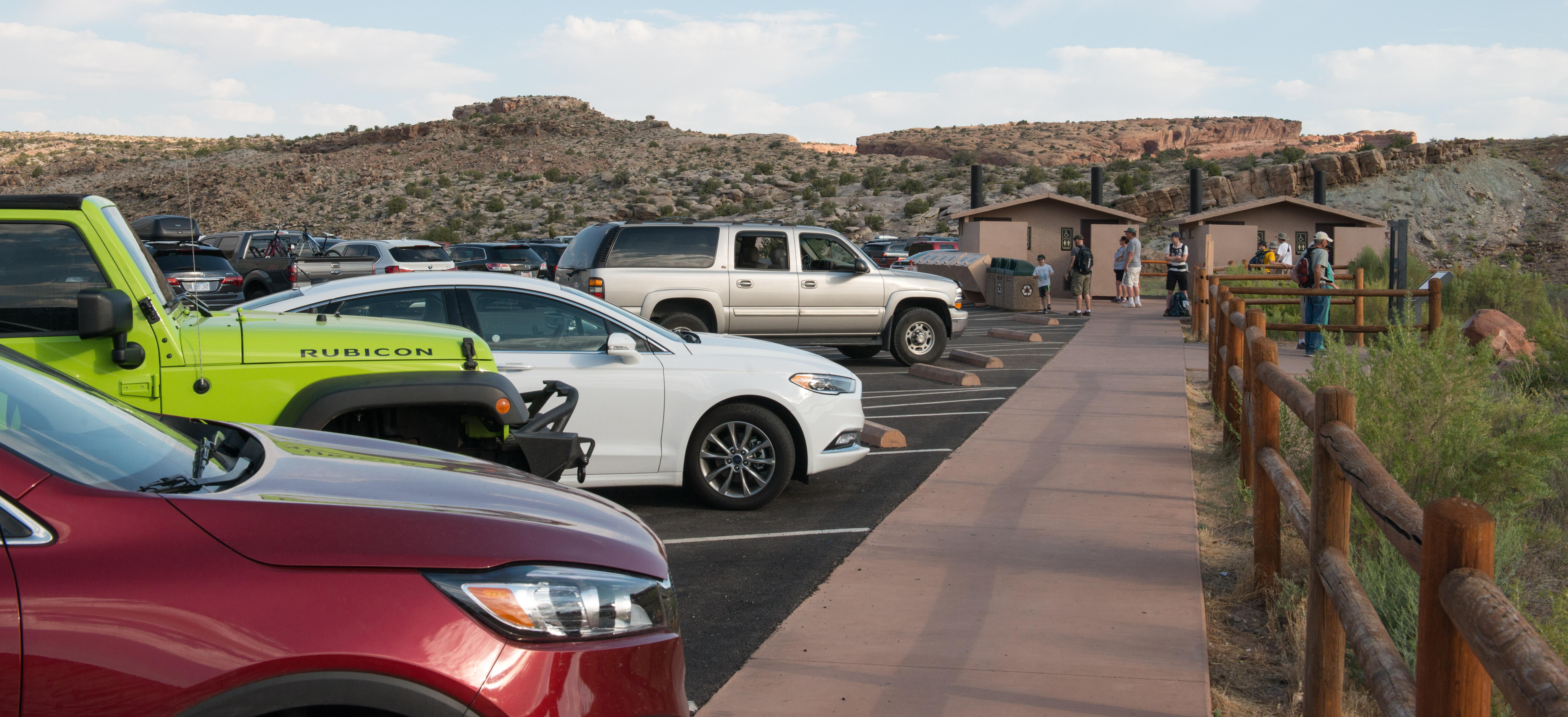 vehicles parked in a parking lot with a sidewalk