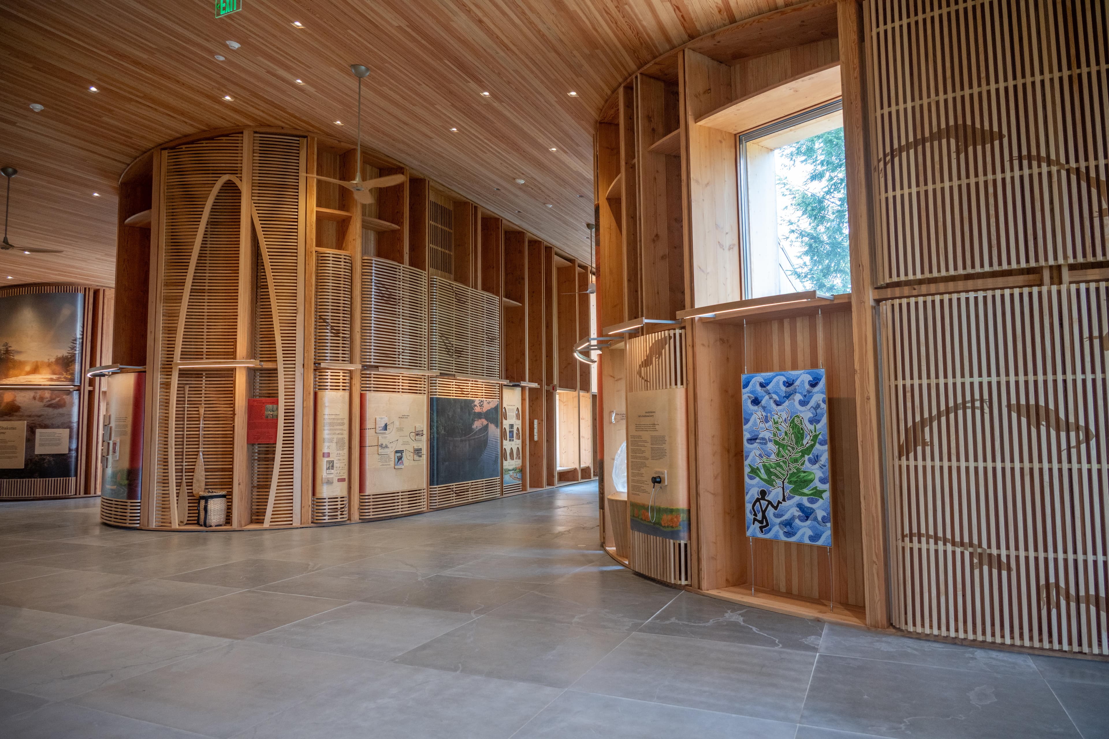 Inside the contact station, wooden paneled, curved, walls, in a warm orange color.
