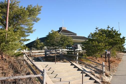 A stairway leads up to a building with a peaked roof.