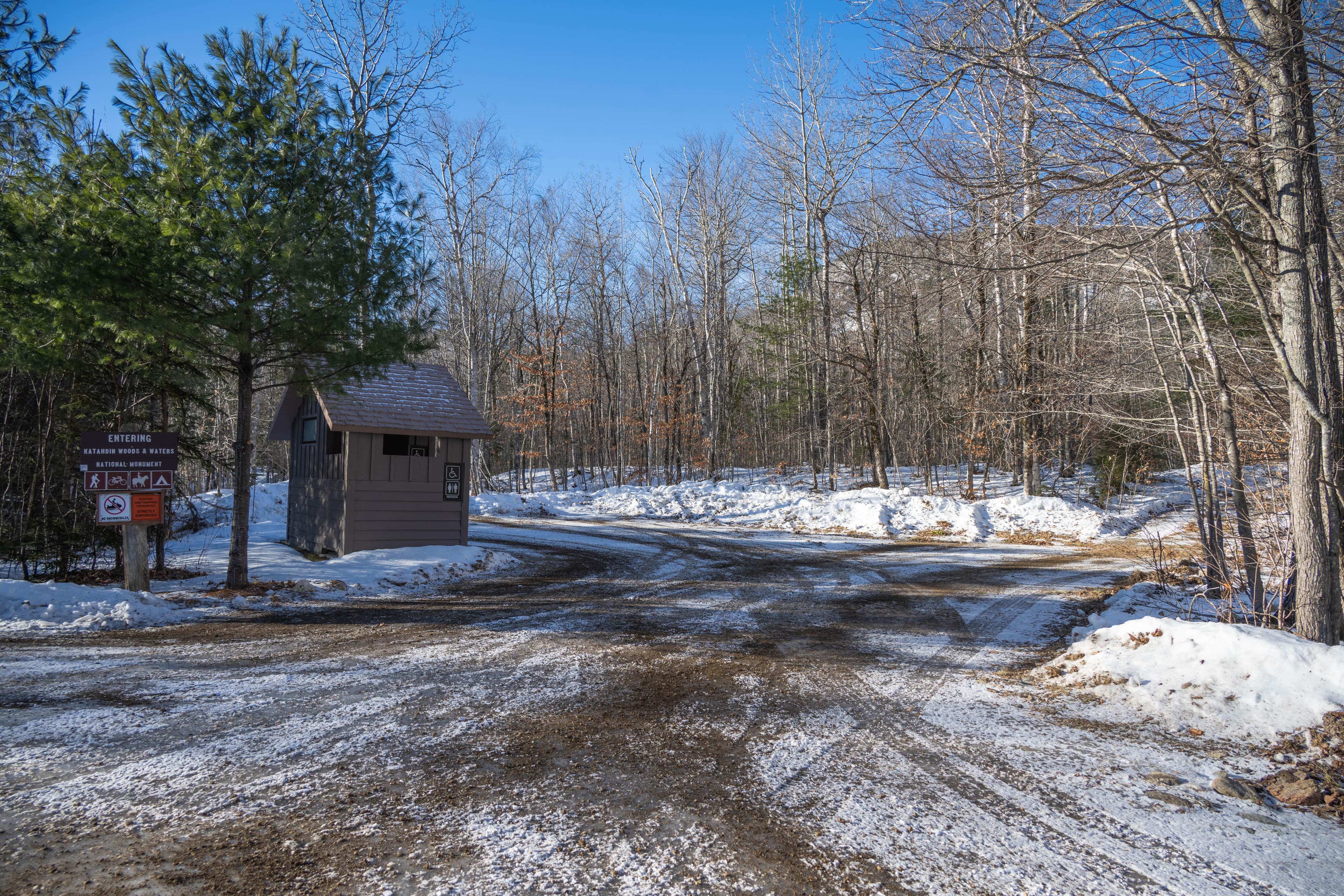 An empty shaded icy parking lot on a sunny day.