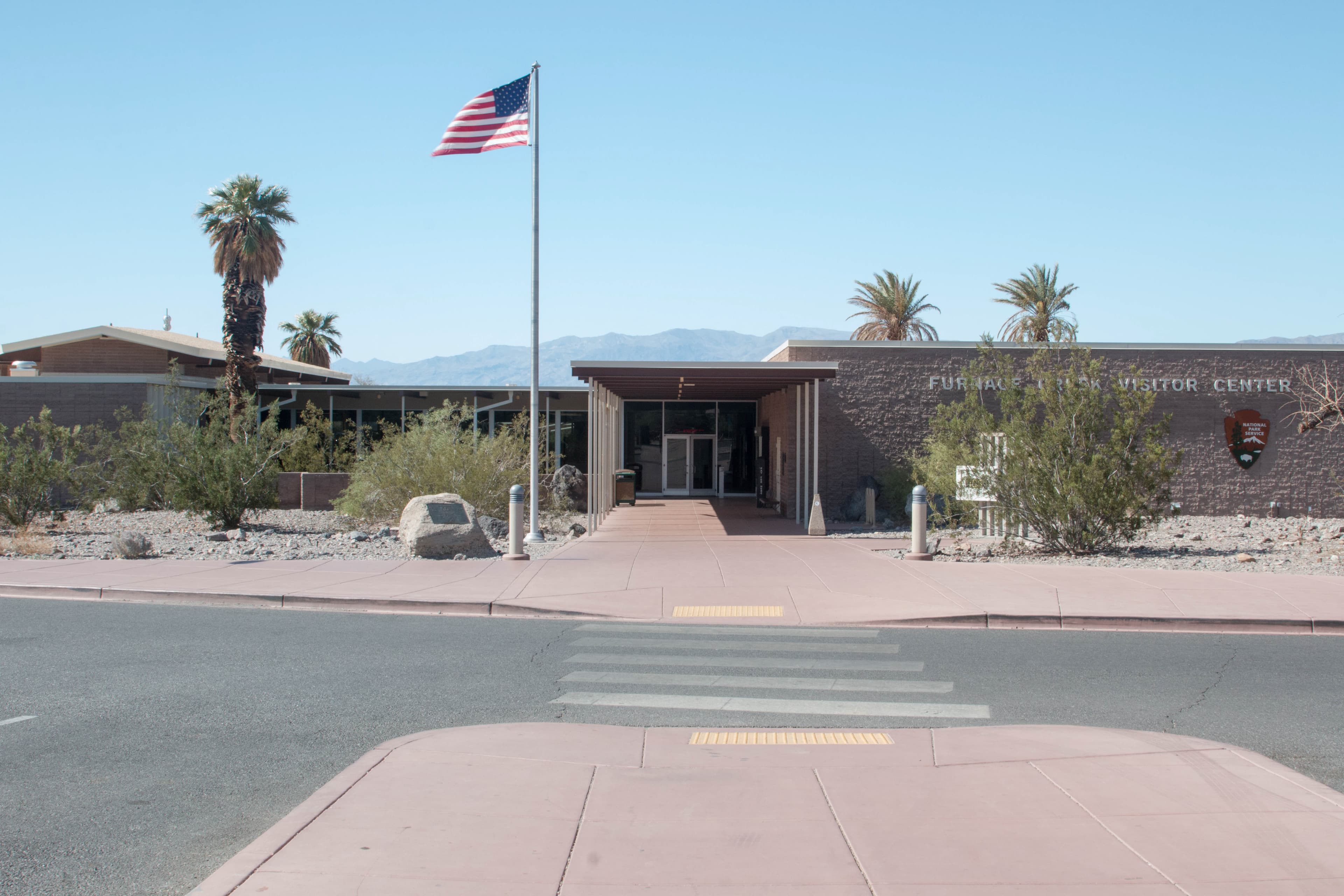 a one story block building and flag pole