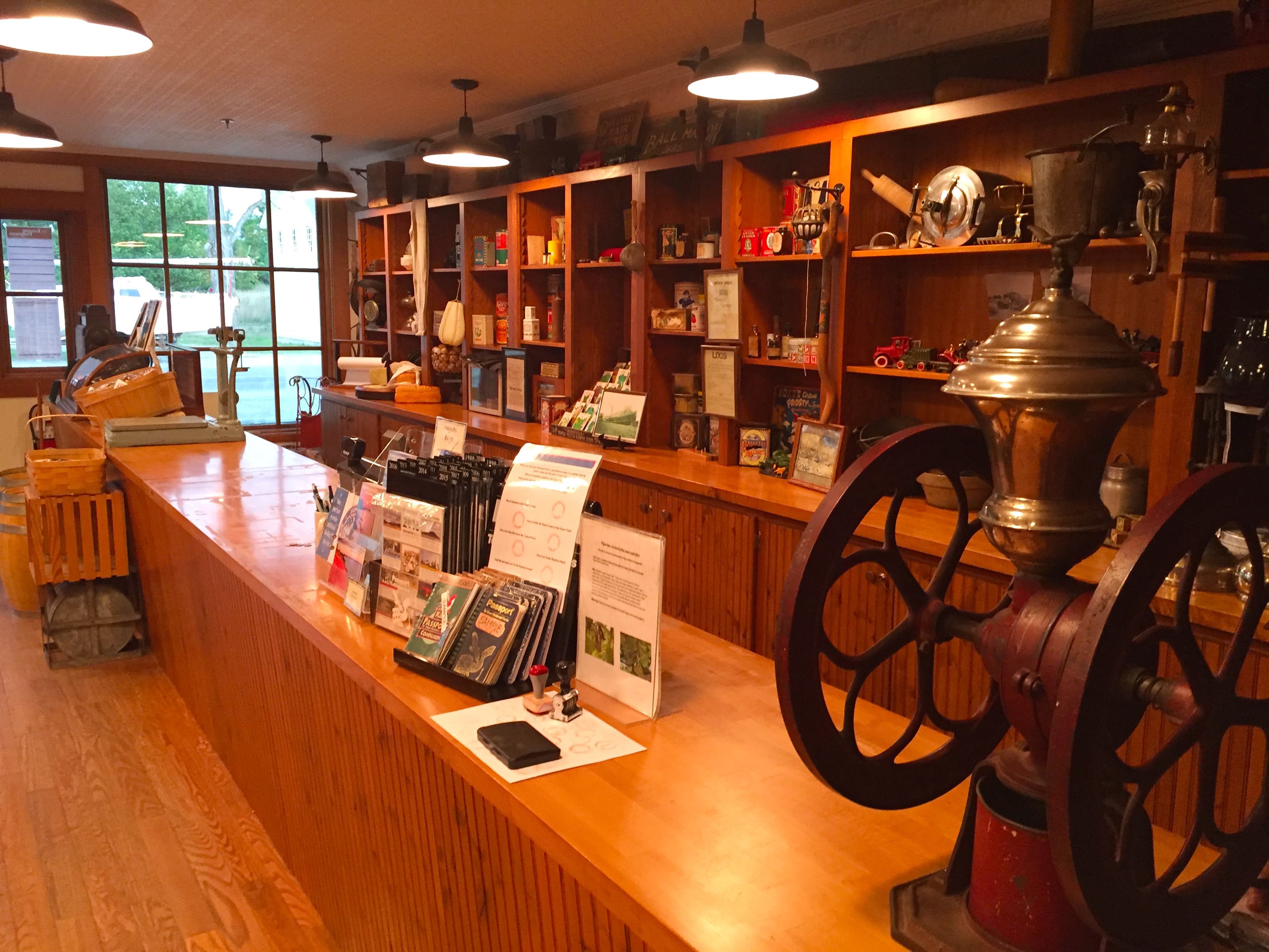 Shelves filled with historic items and an old coffee grinder on counter.