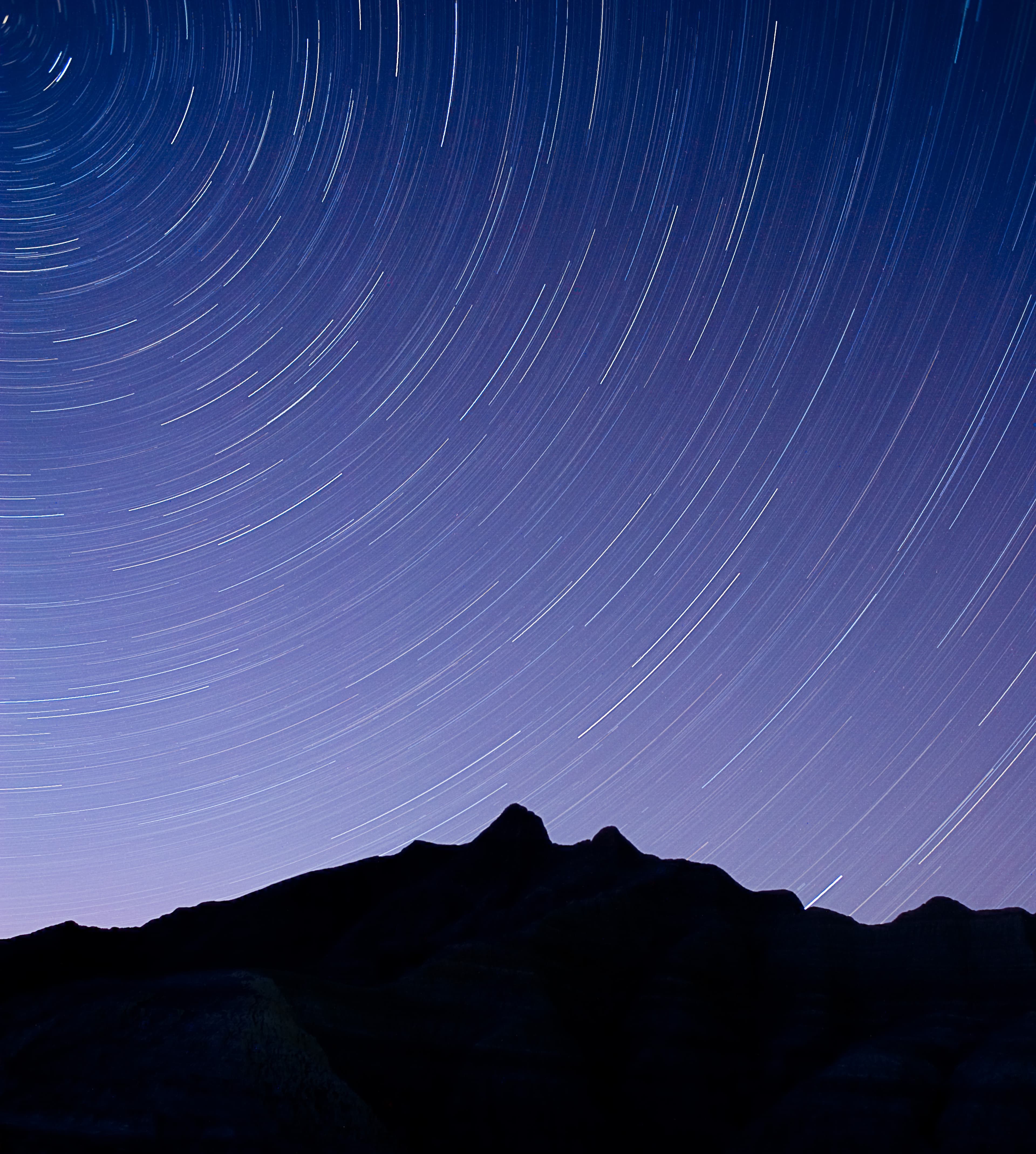 stars whir around the silhouette of a badlands butte in a circular motion