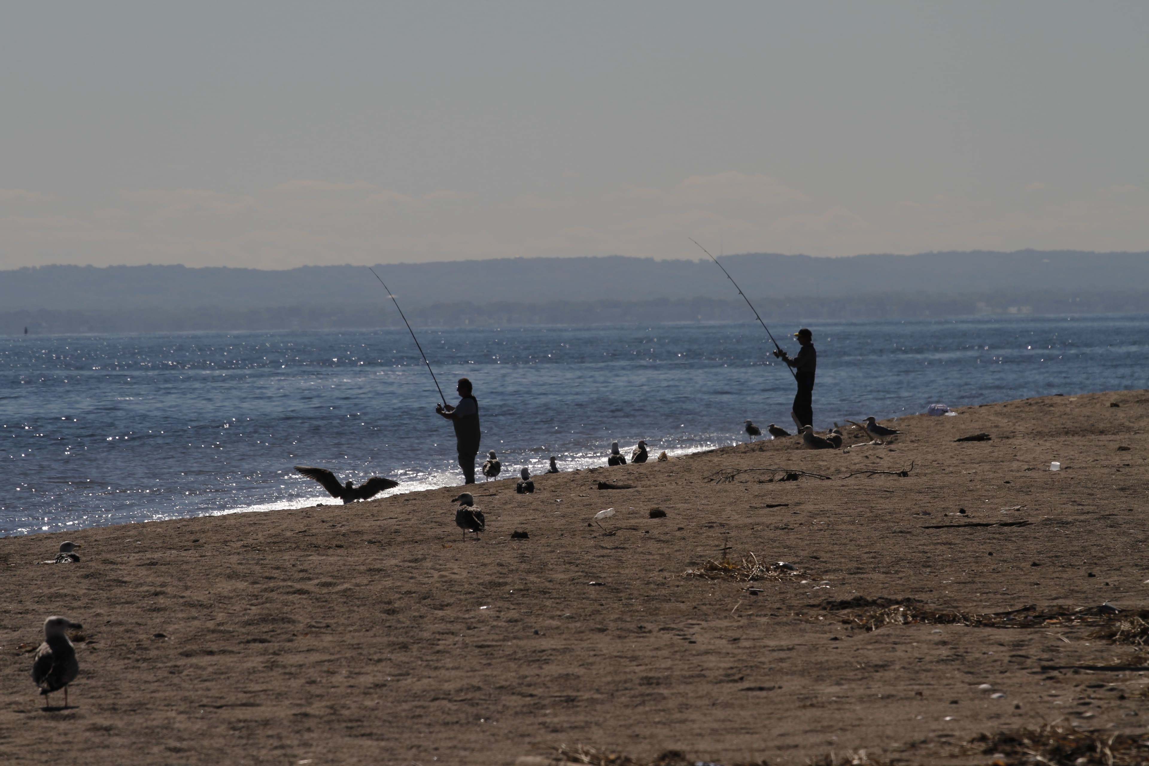 Silhouette of fishermen on the beach