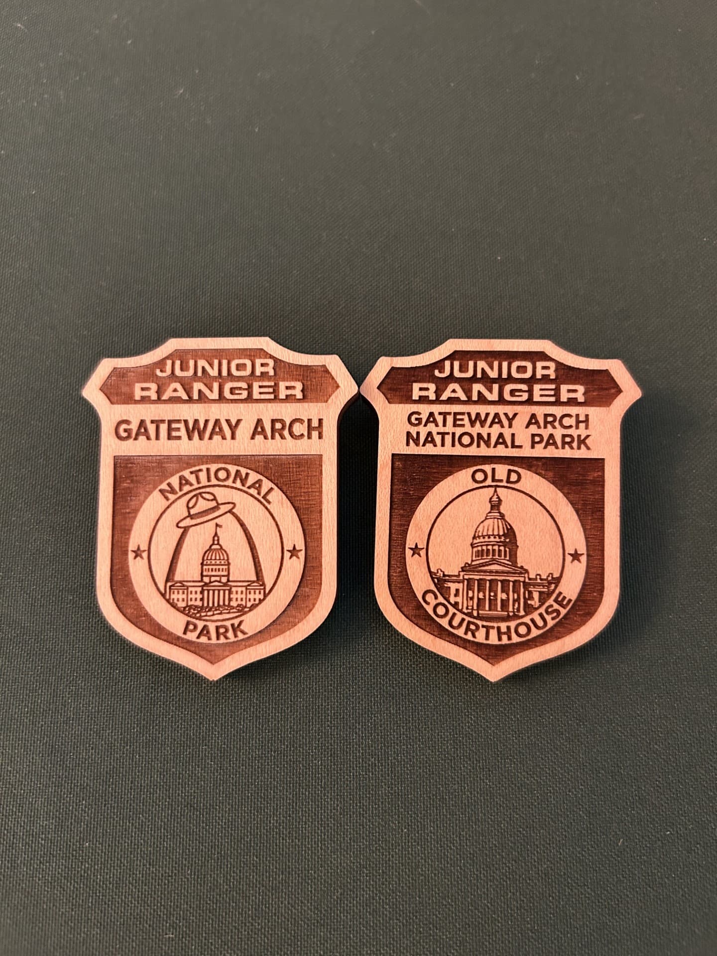 Two wooden badges sit side by side