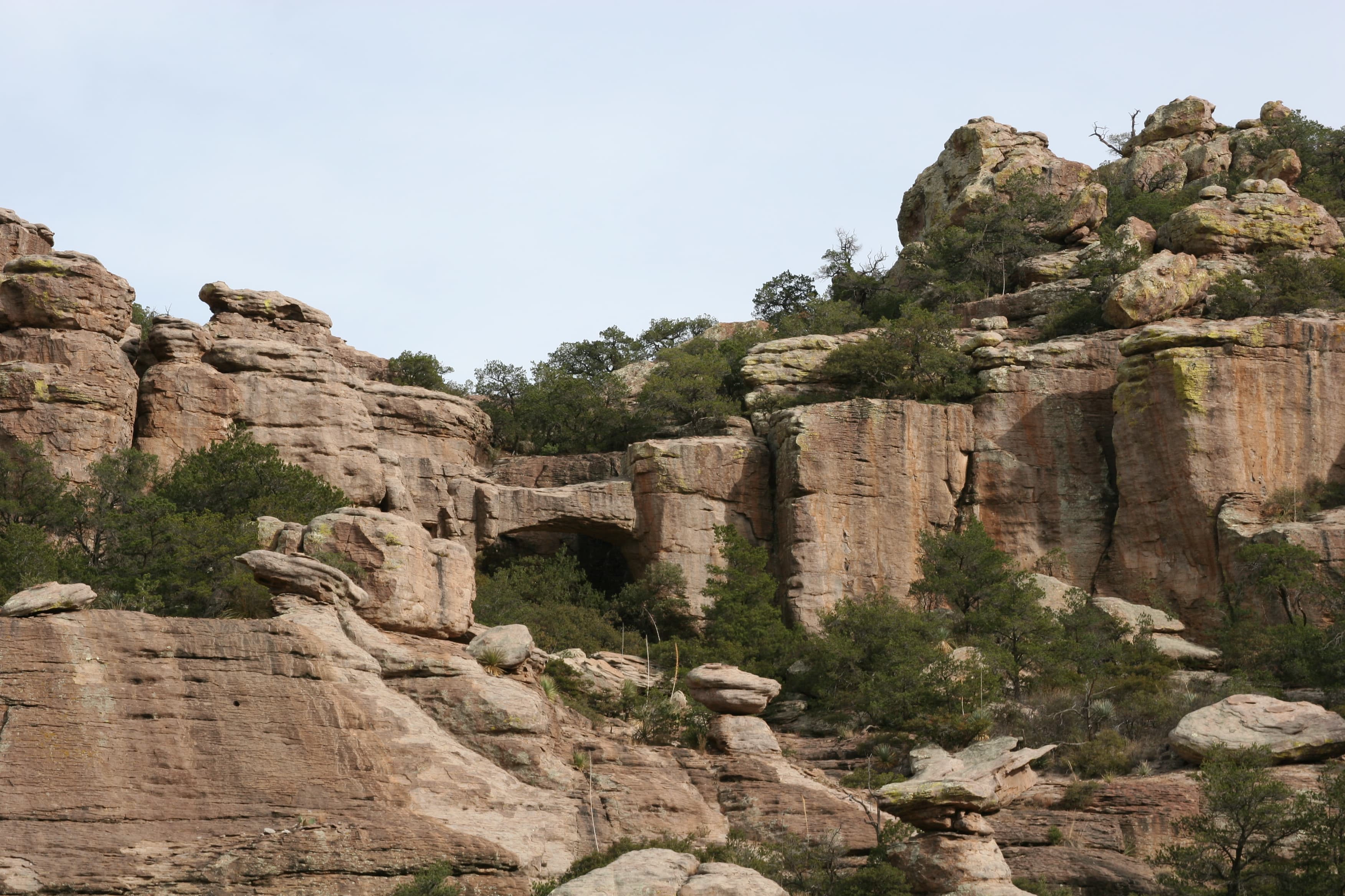 Rock formations with a natural bridge featured.