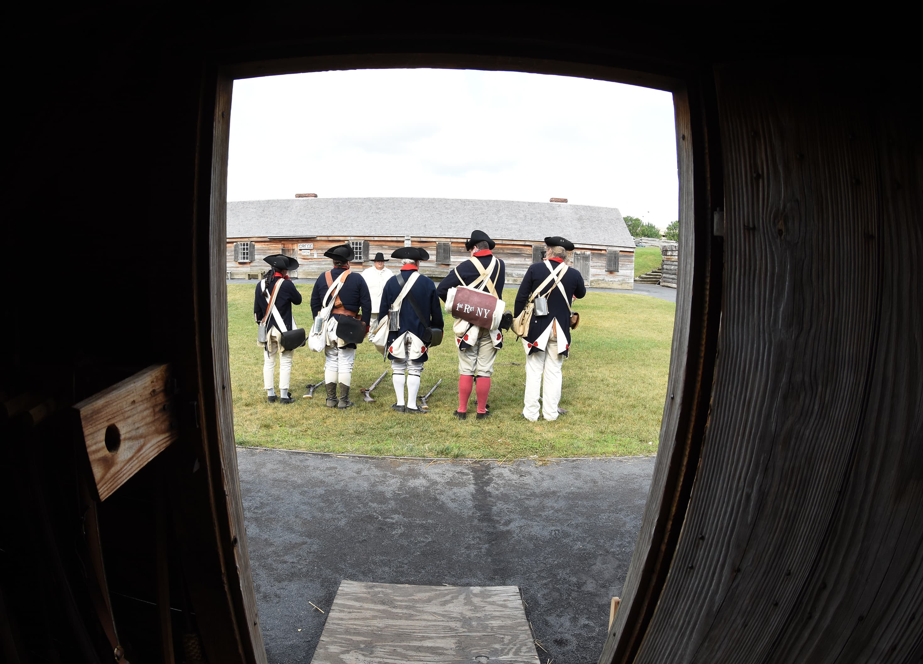 Out of a doorway, you can see several Continental soldiers standing in a line, facing away from you.