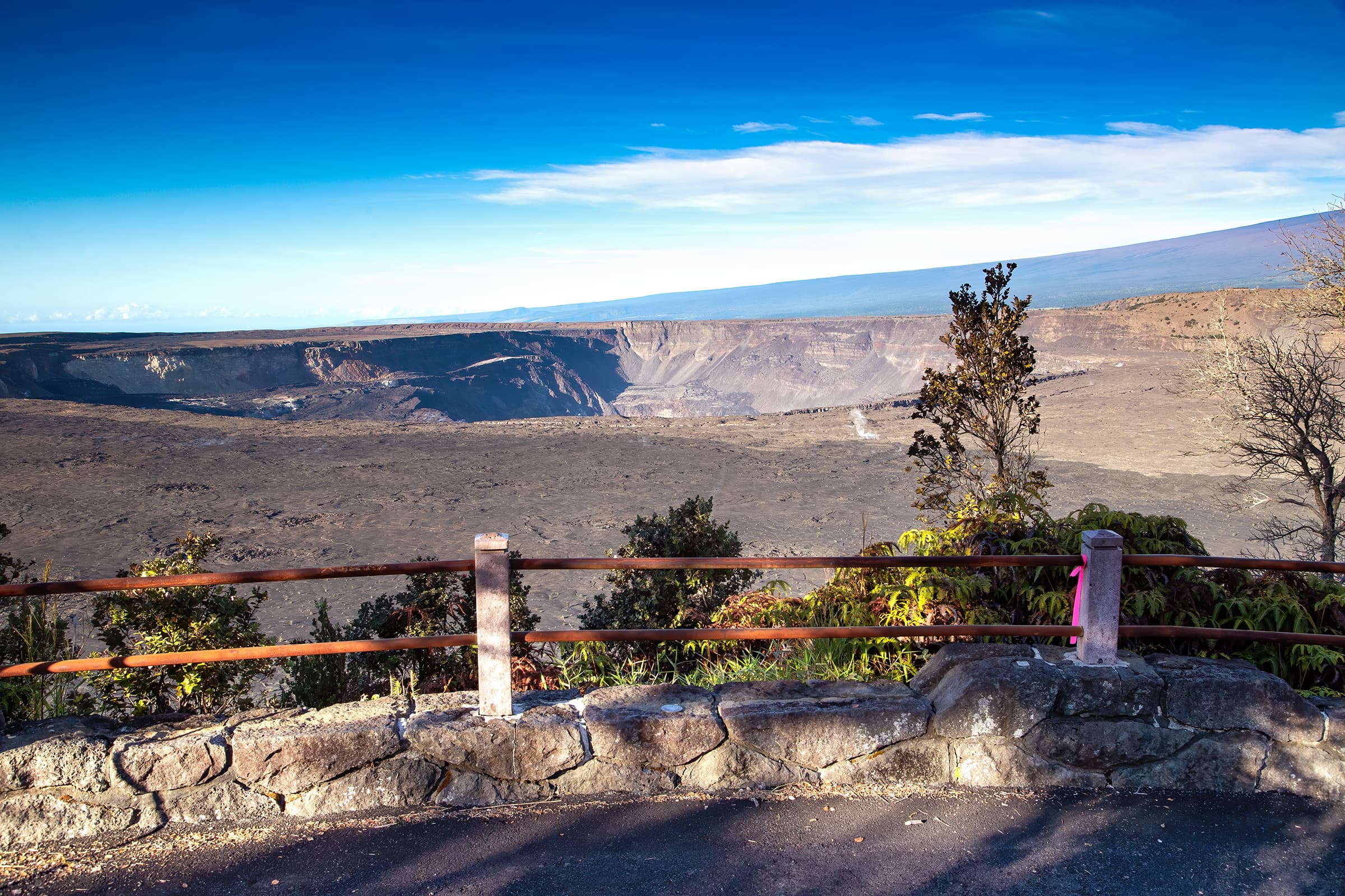 Overlook into a volcanic crater with trees in the foreground