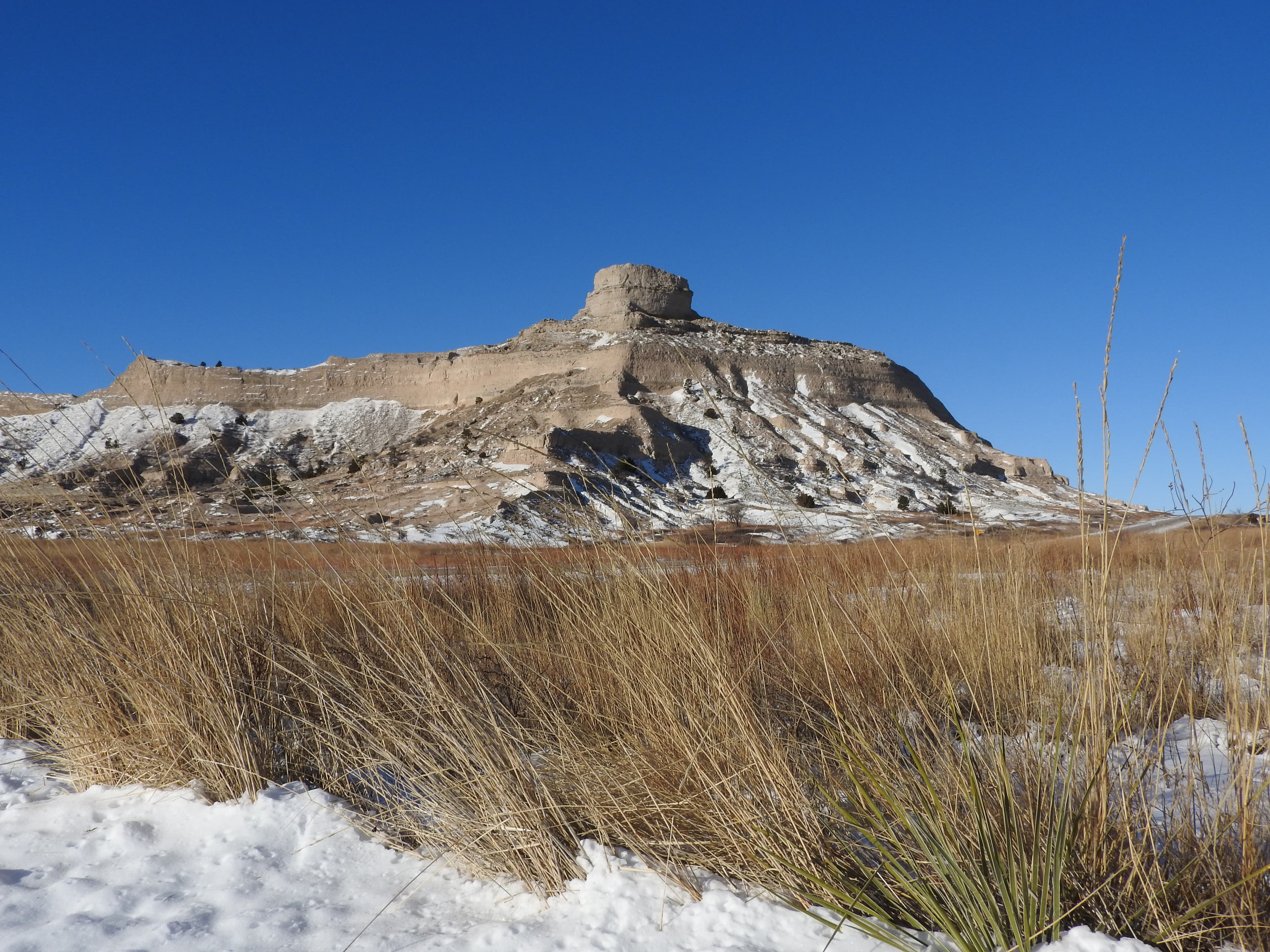 A sandstone bluff is dusted with snow.