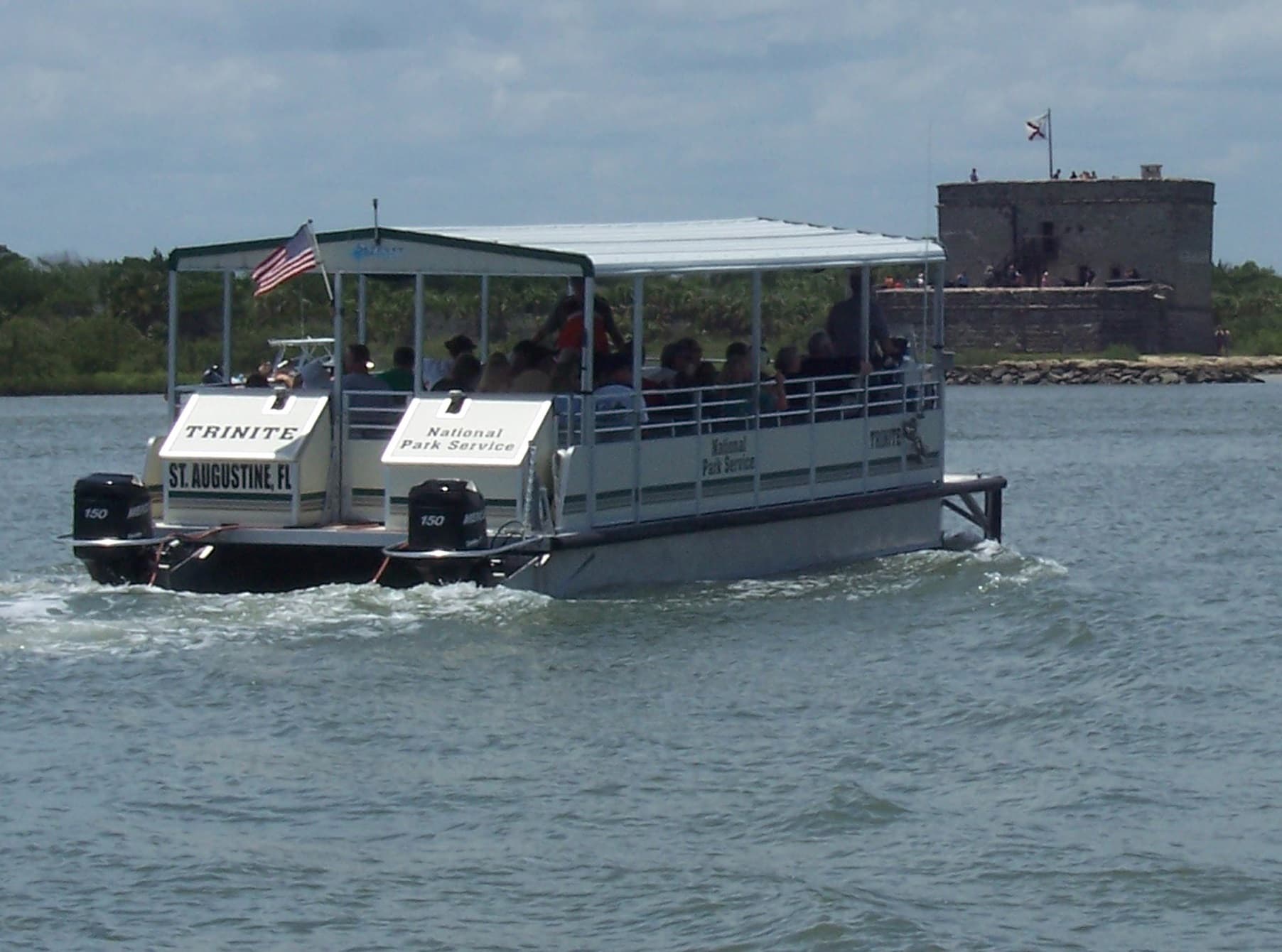 Ferry boat in the water with the Fort in the background