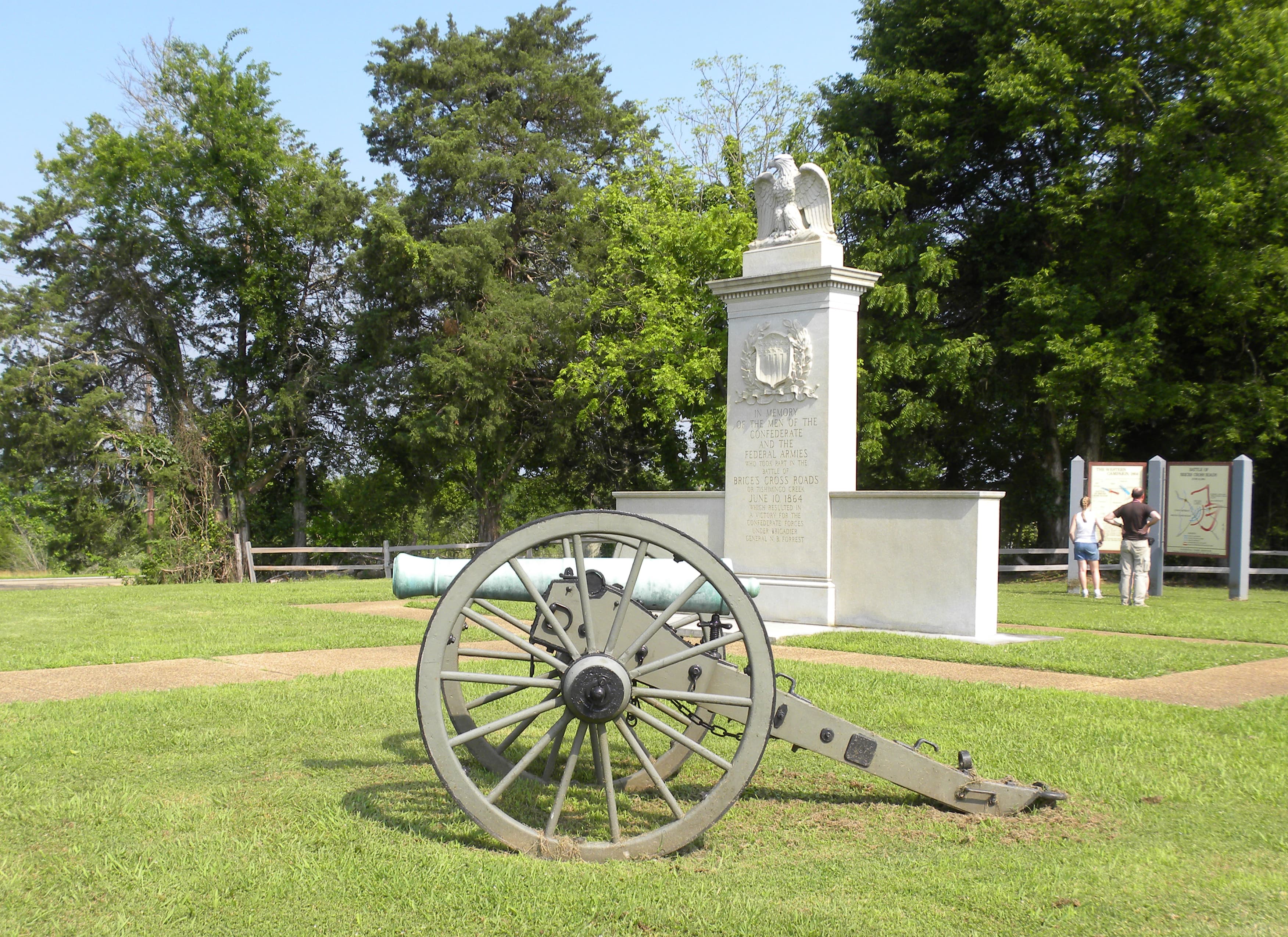 Brices Cross Roads National Battlefield Monument in middle with cannon in front.