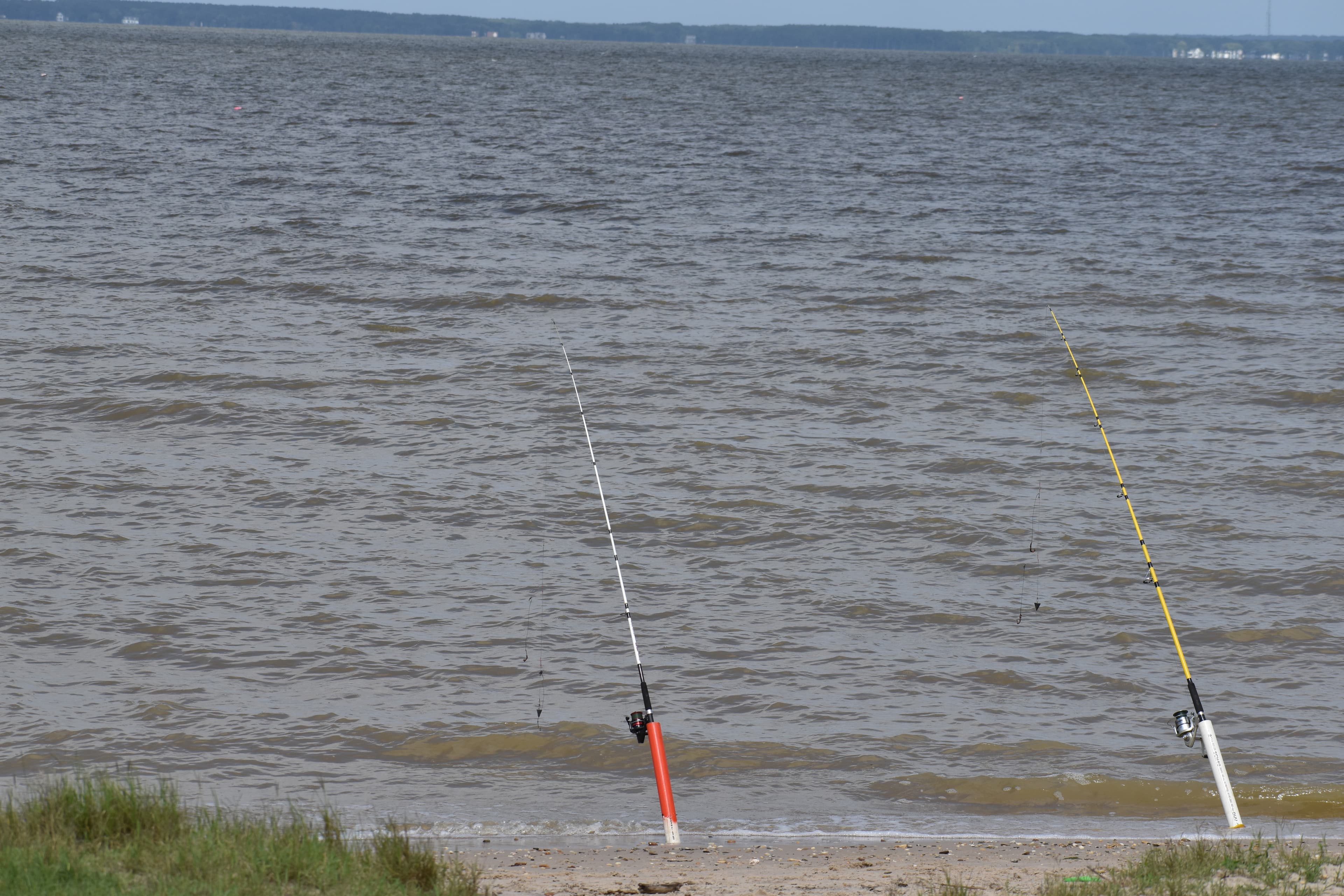 Two fishing rods with lines cast in water