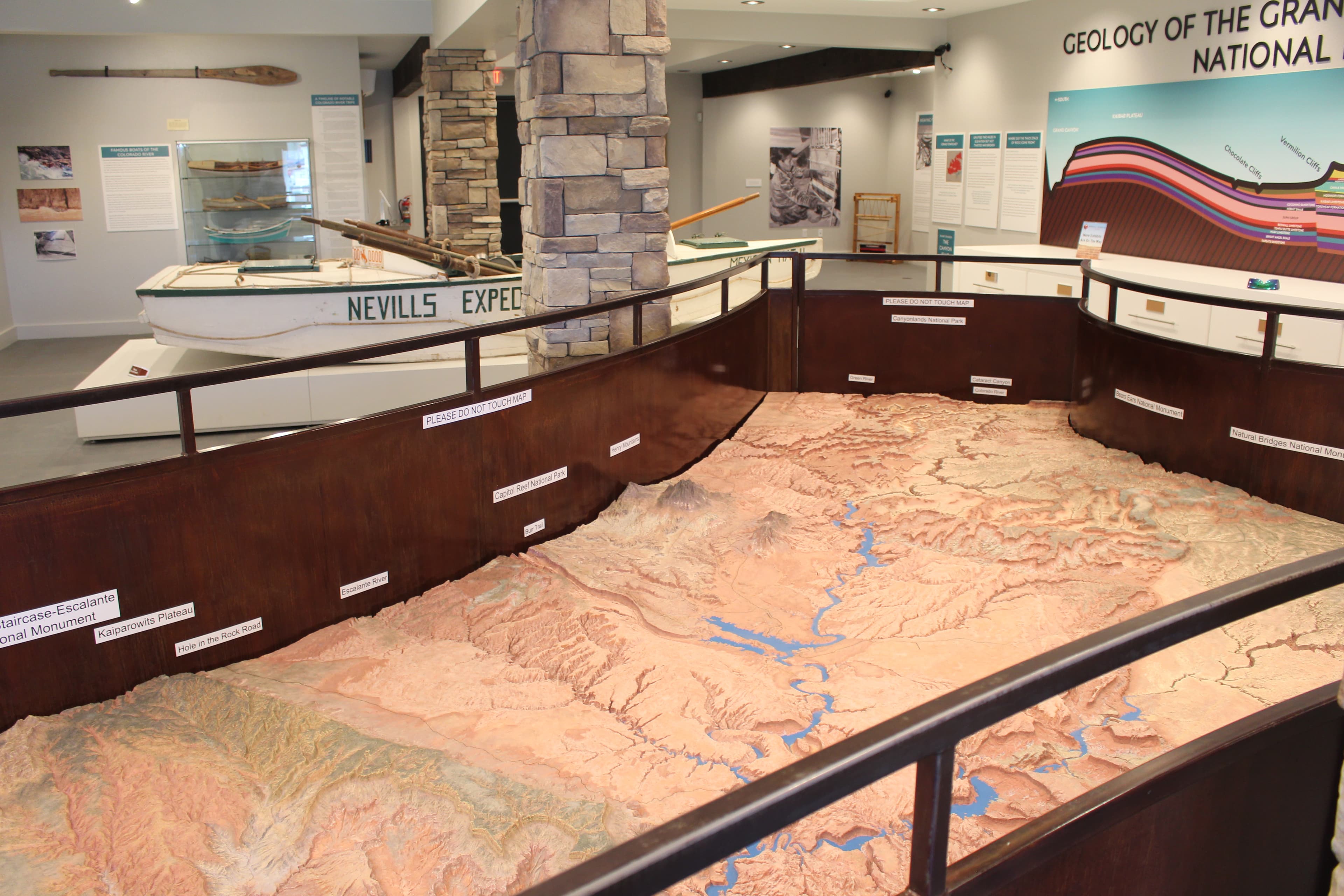 Relief map depicting desert landscape with a man-made lake. Metal railings