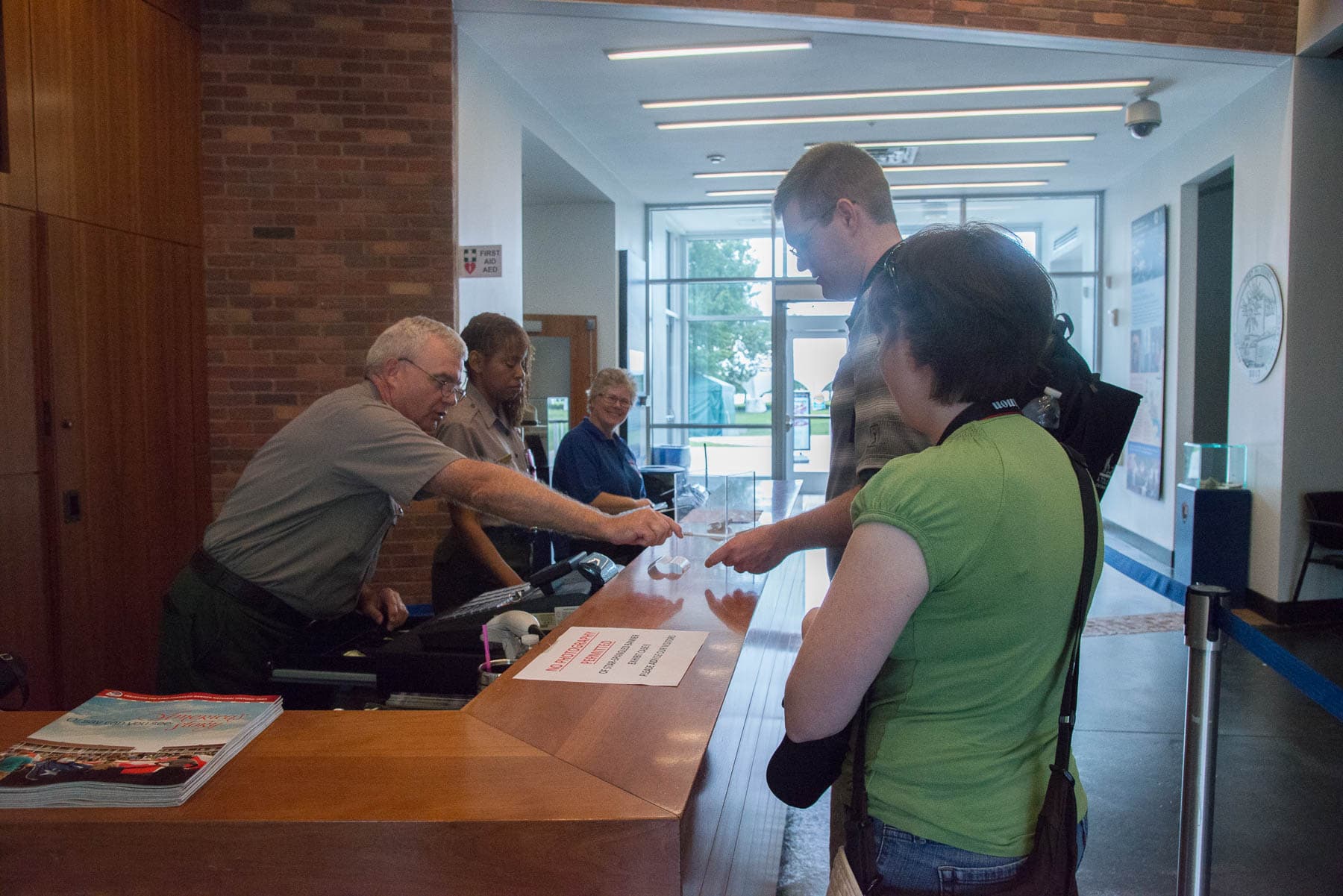 A ranger gives directions at the visitor center desk.