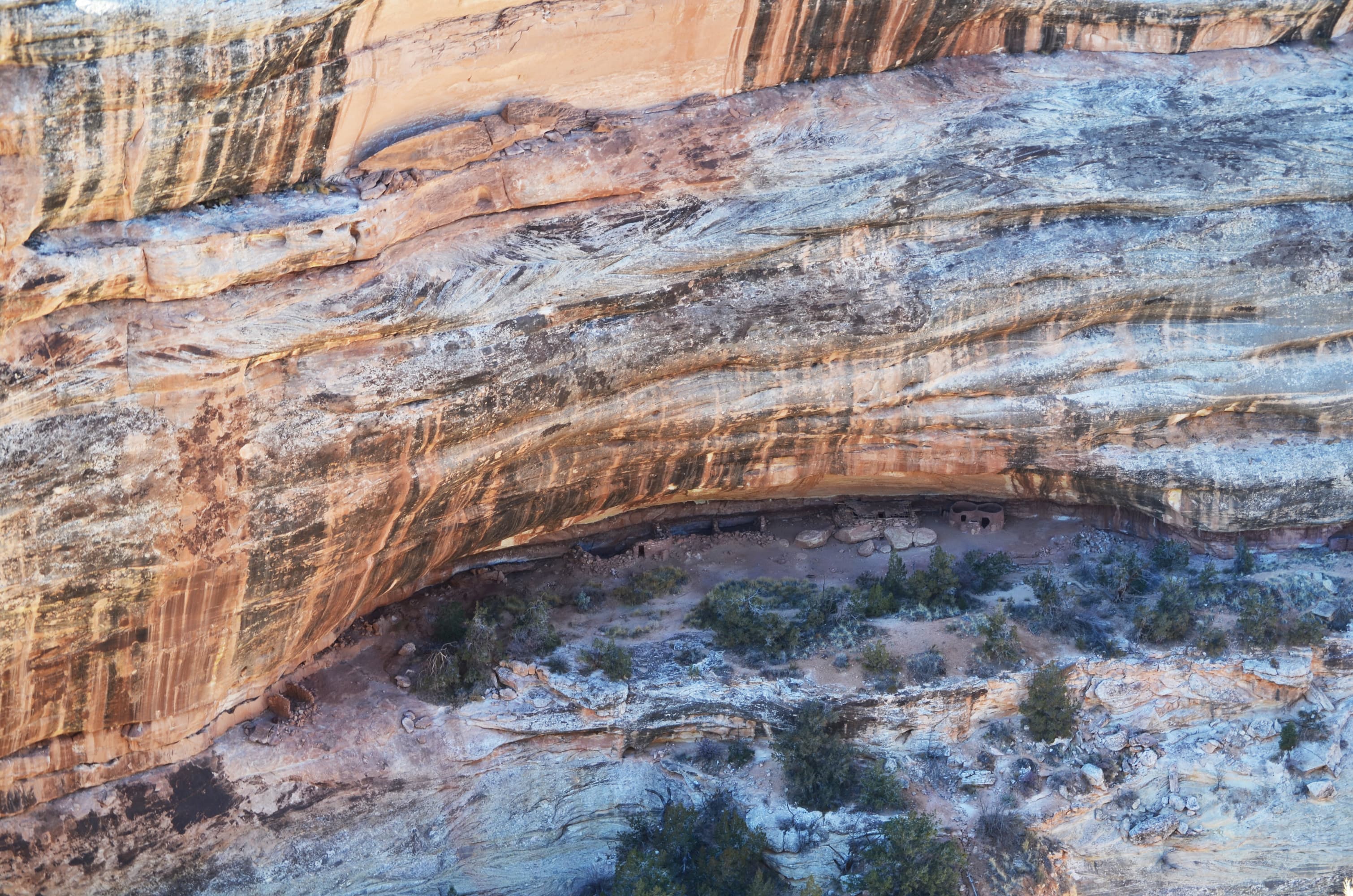 circular stone structures tucked into an alcove in the cliff-side