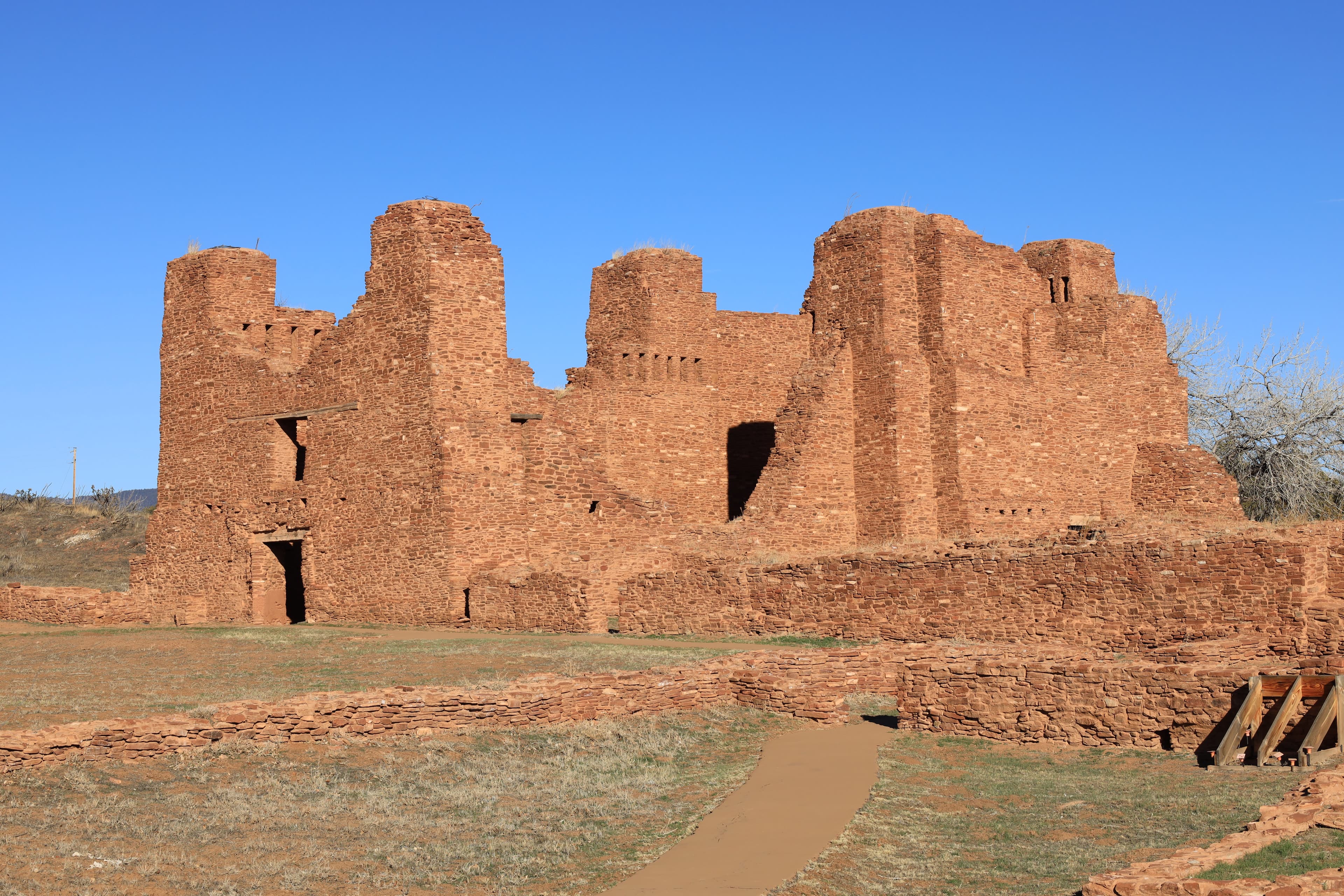 Red sandstone church remnants against a blue sky background.