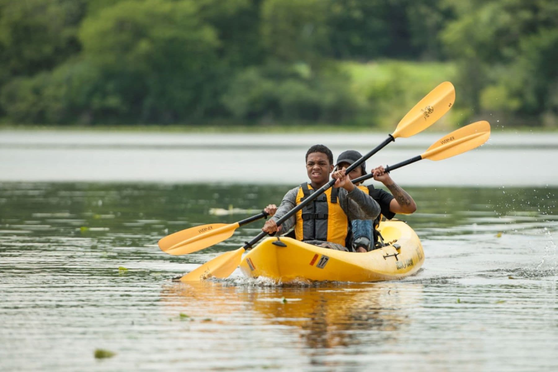 Two persons in a kayak on the river.