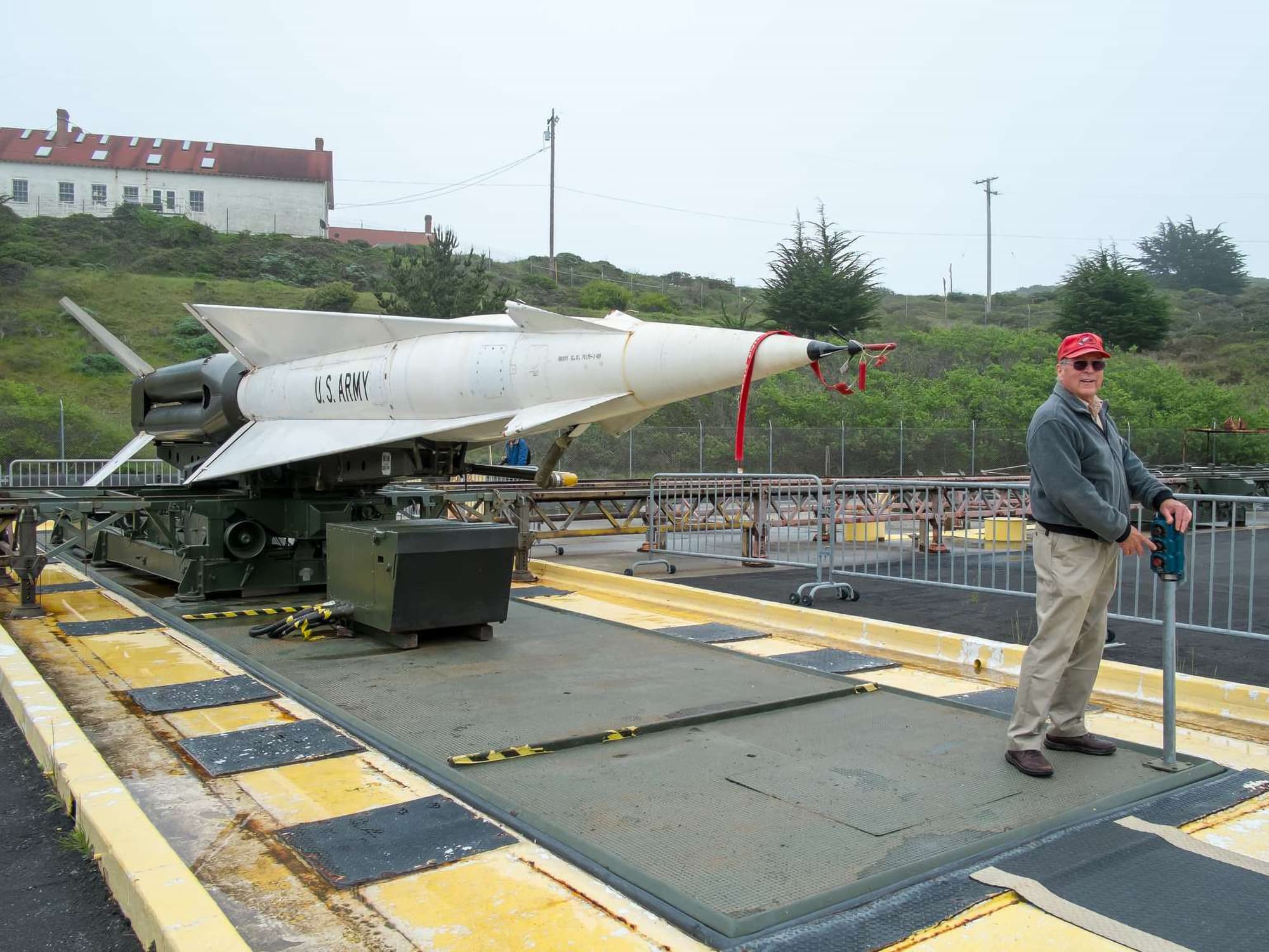 A volunteer demonstrates how a Nike missile rises from storage below ground.
