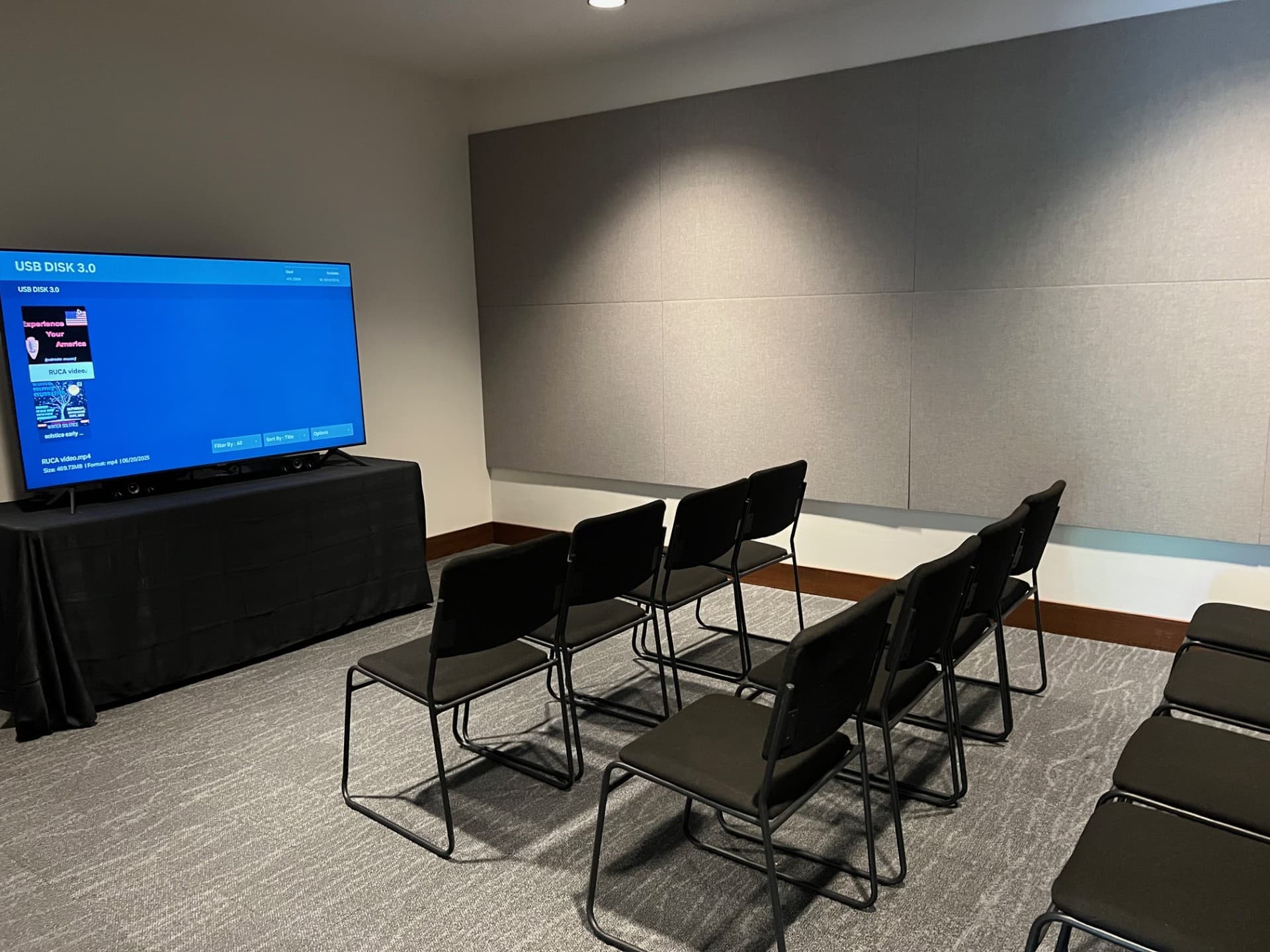 tv screen with black chairs
