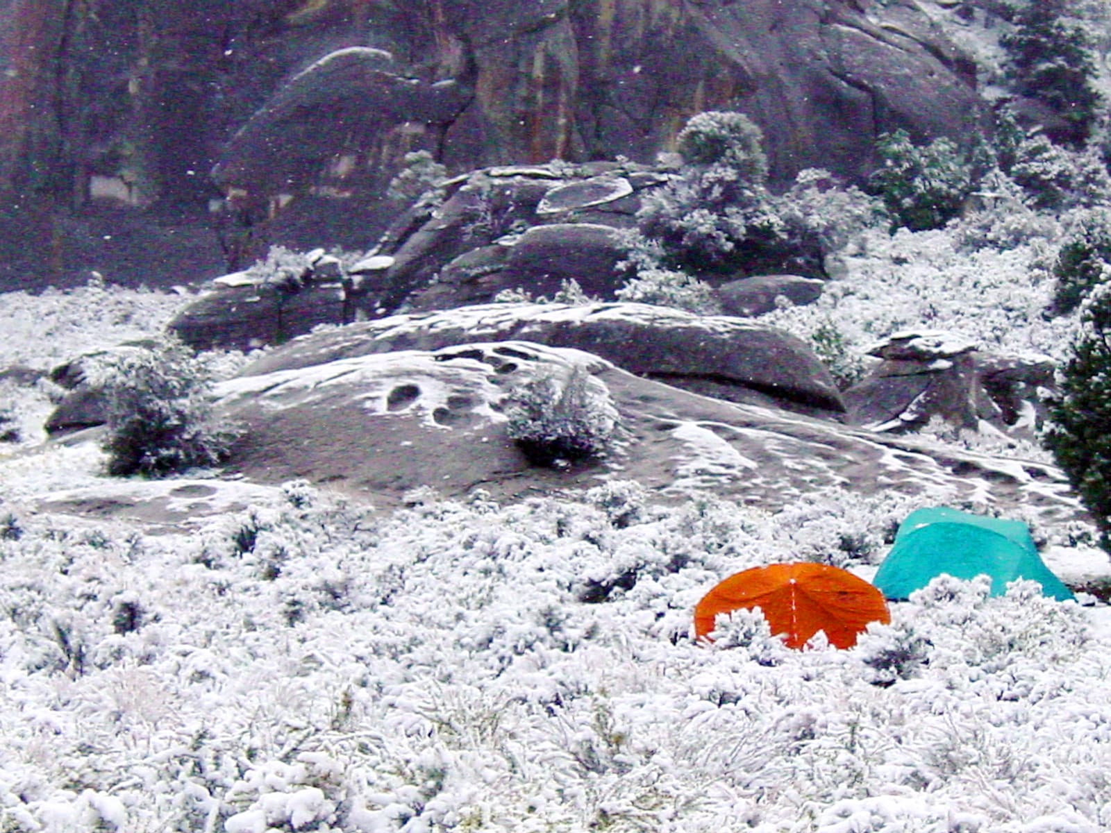 Two tents in the snow at a campsite in the City of Rocks.