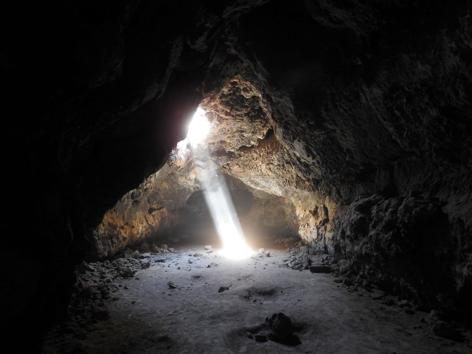 A beam of light shines into the lava tube
