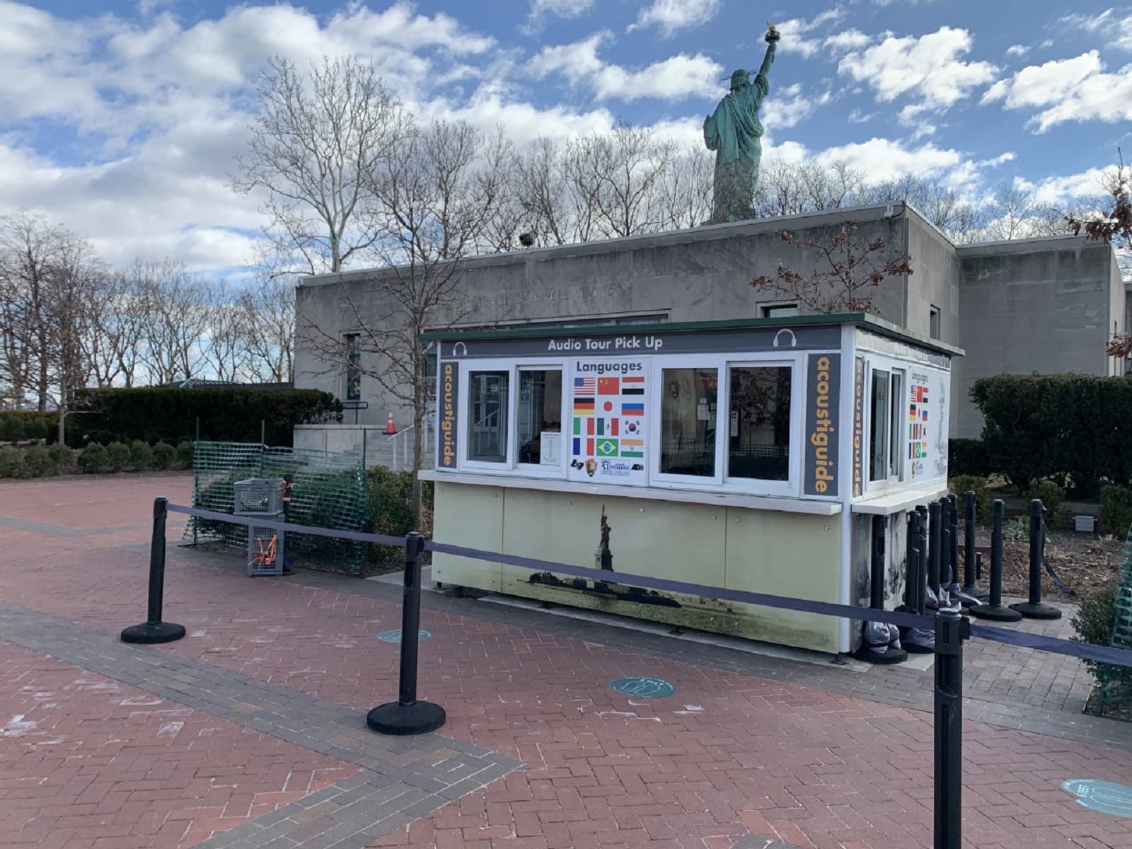 A white kiosk with large windows is available for visitors to pick up an audio guide