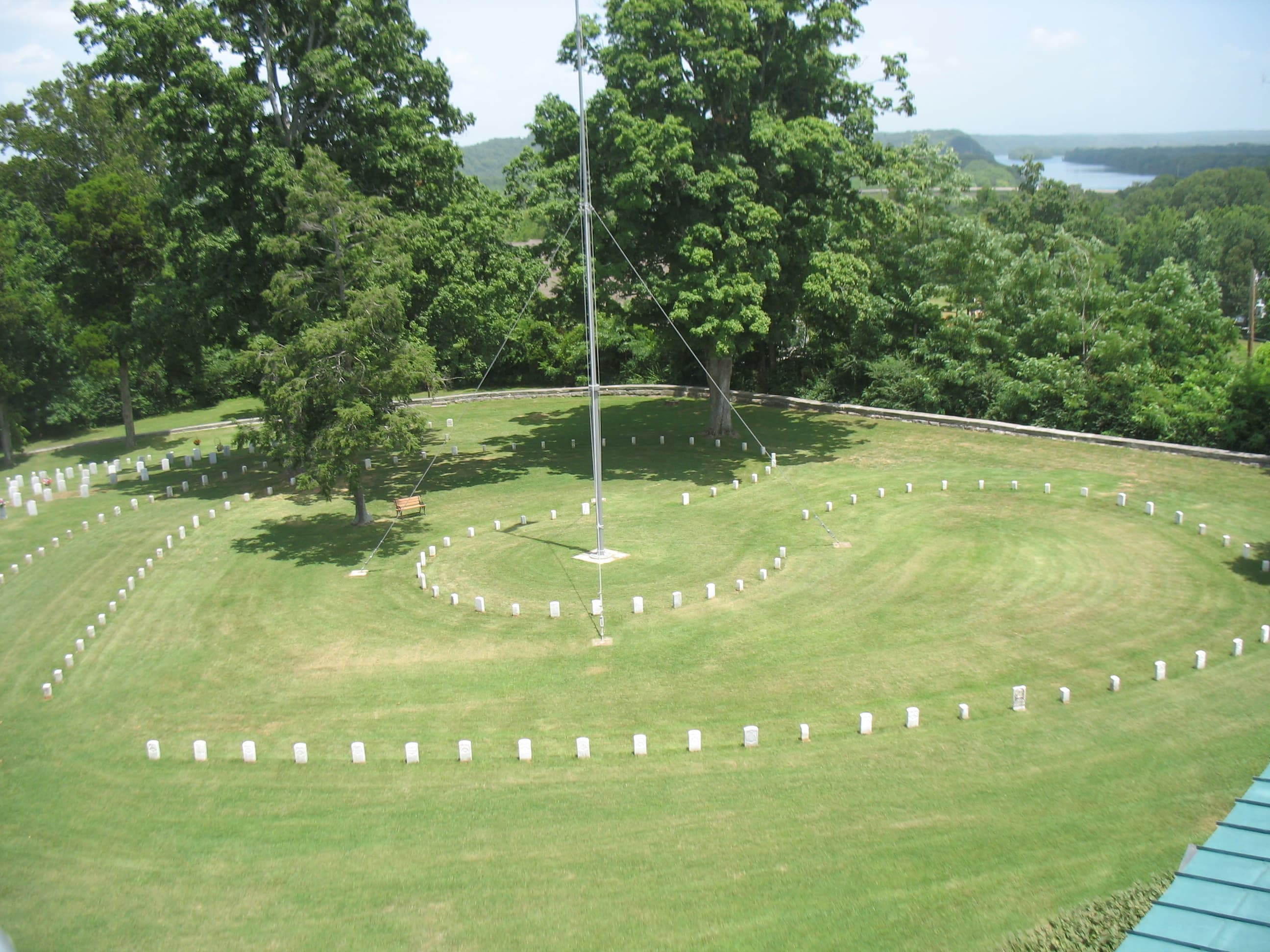 lawn with headstones and flagpole in cemetery