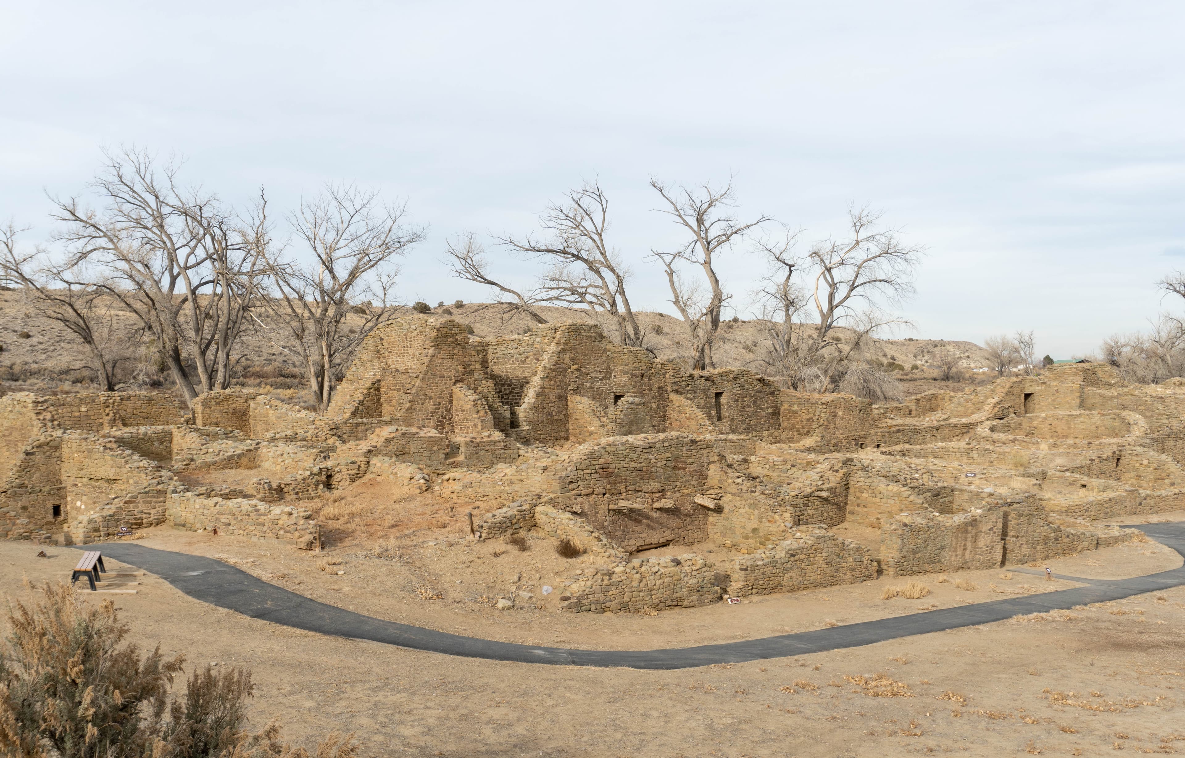 A photo of the Great House with a blacktop trail in the foreground.