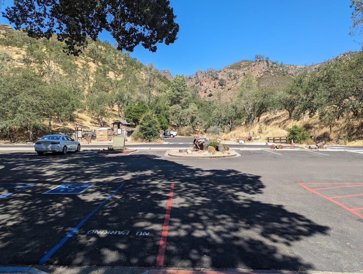 View of rock formations from a paved day use area and parking