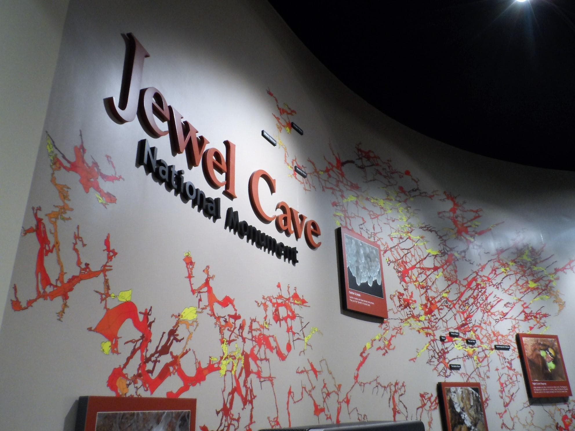 A large cave map is attached to a wall, with the words Jewel Cave National Monument above the map.