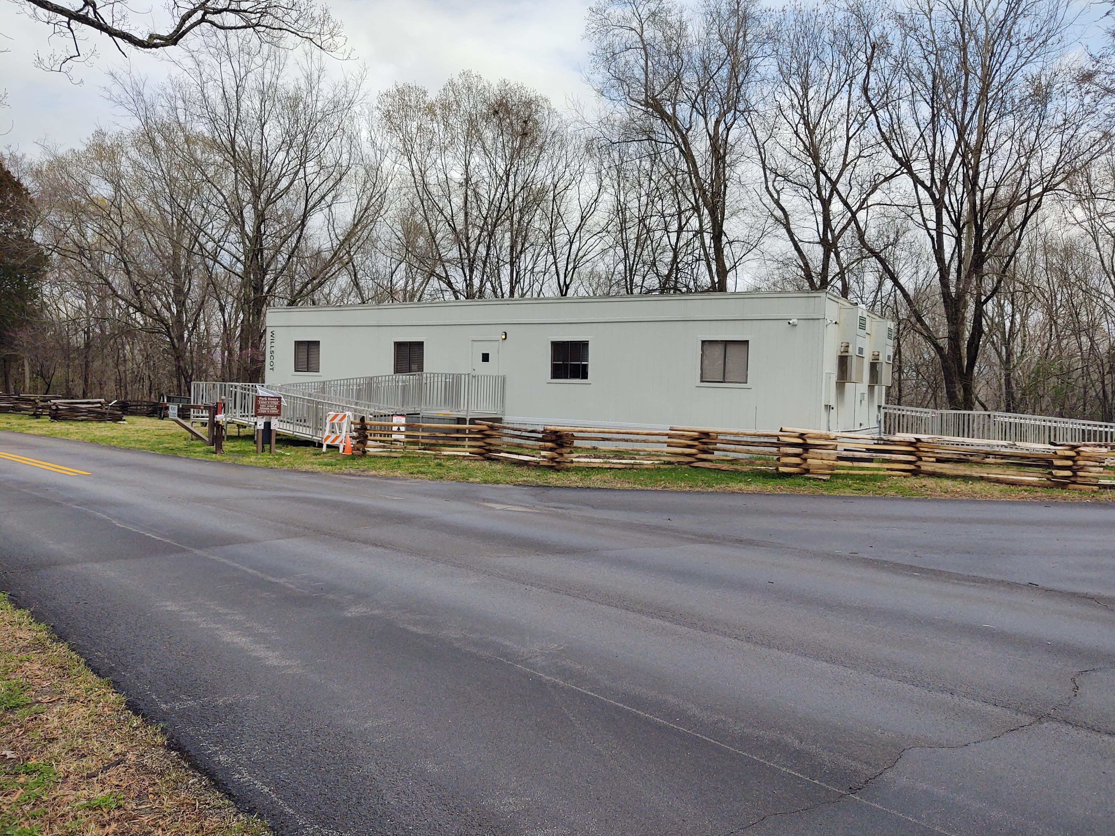 A white temporary modular building north of parking lot