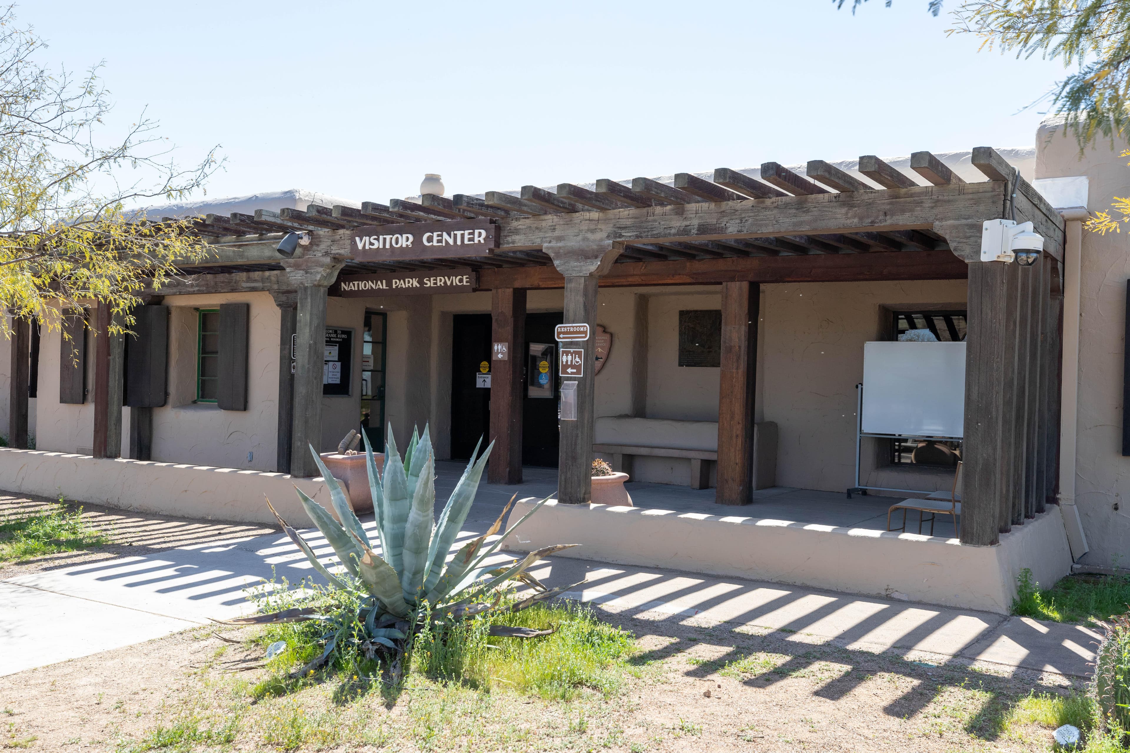 The entrance to a building with a sign that reads, Visitor Center