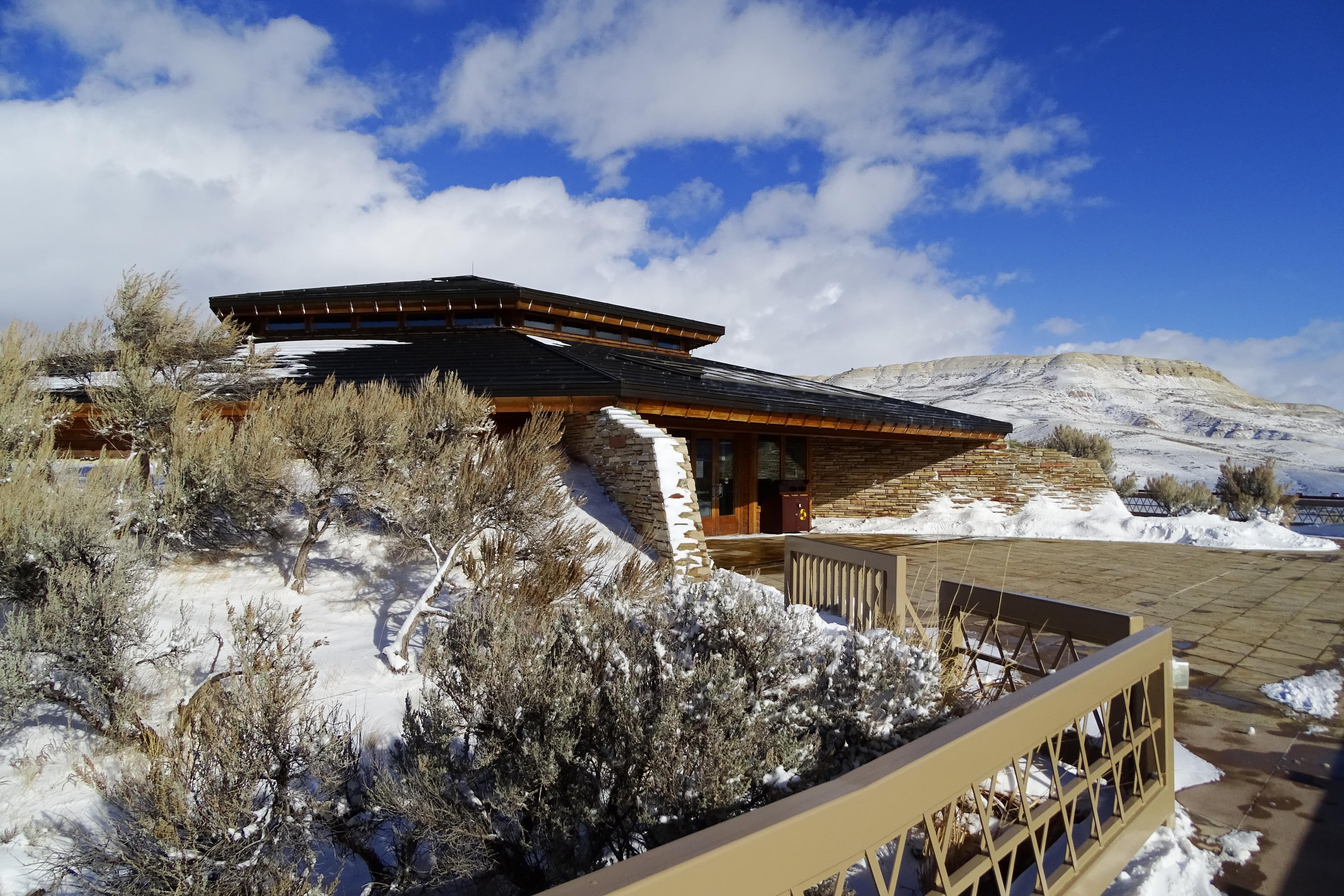 A building with Fossil Butte behind, covered in snow.