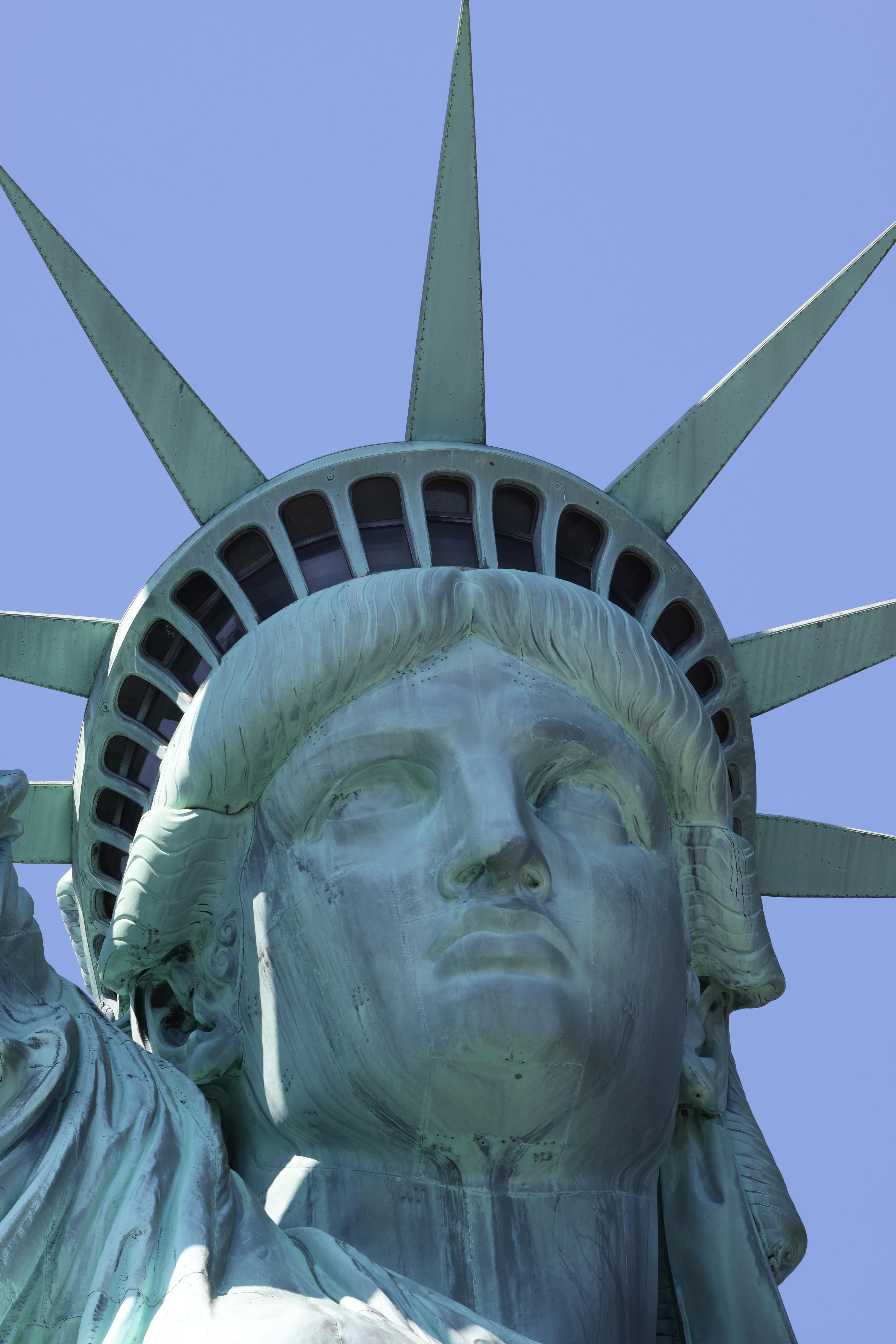 A close-up of the Statue of Liberty's face and crown.
