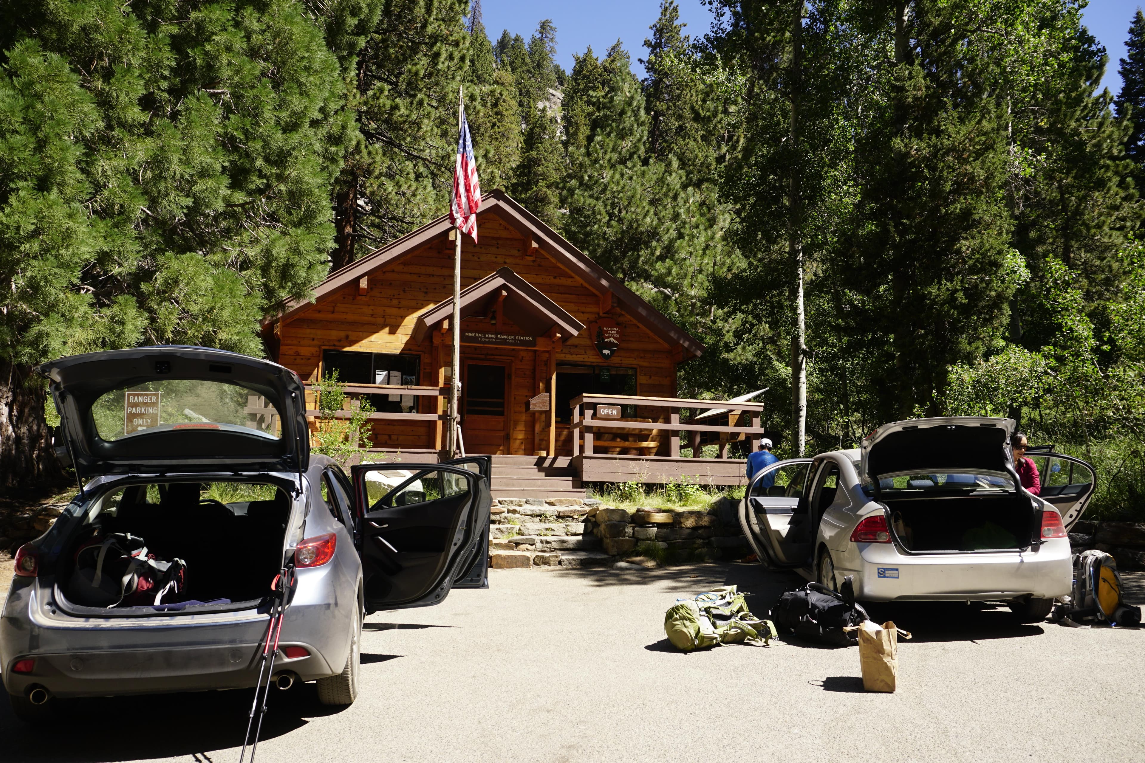 Cars parked in front of a rustic building