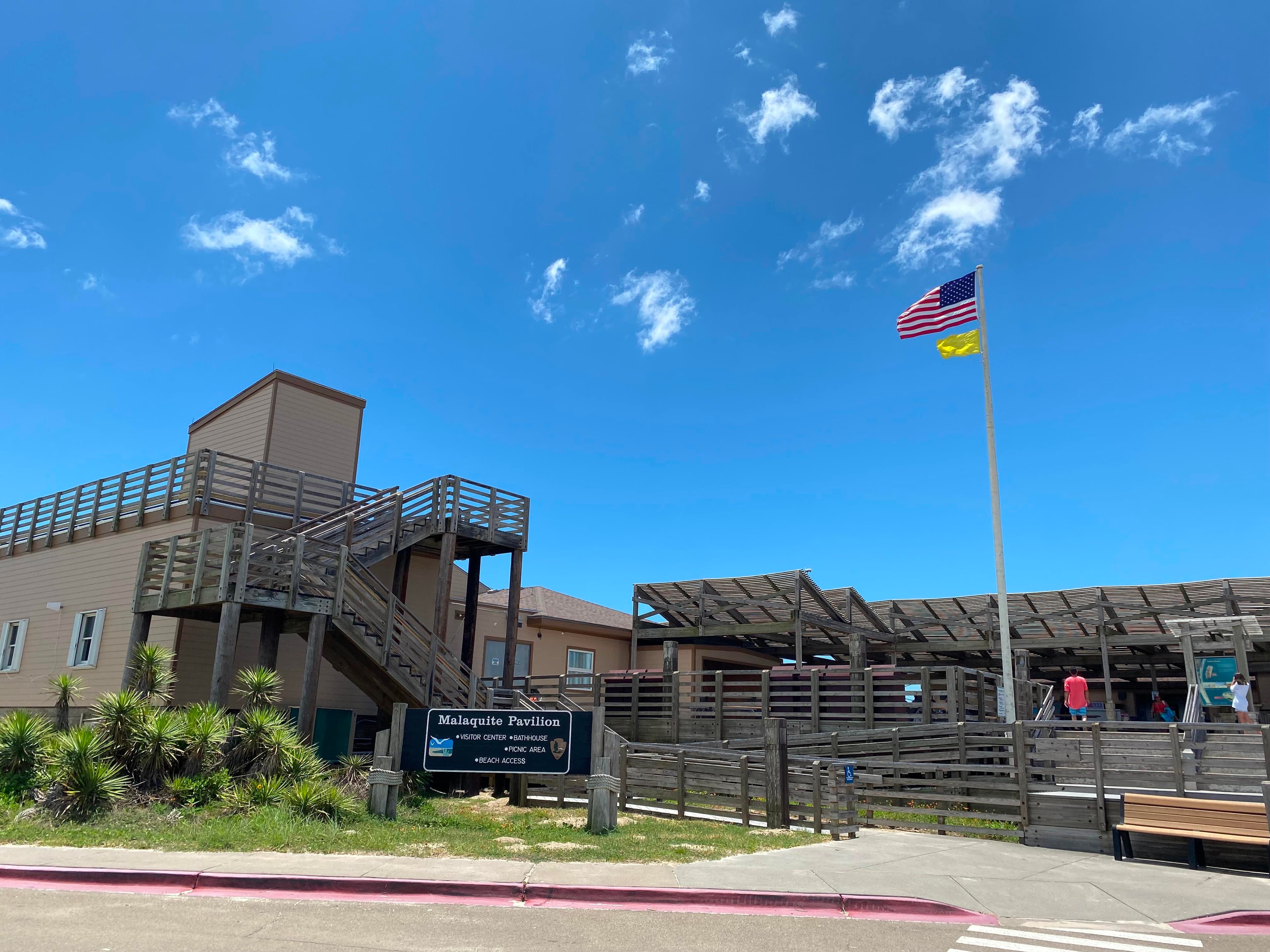 A tan building with wooden stairs and decks around it.