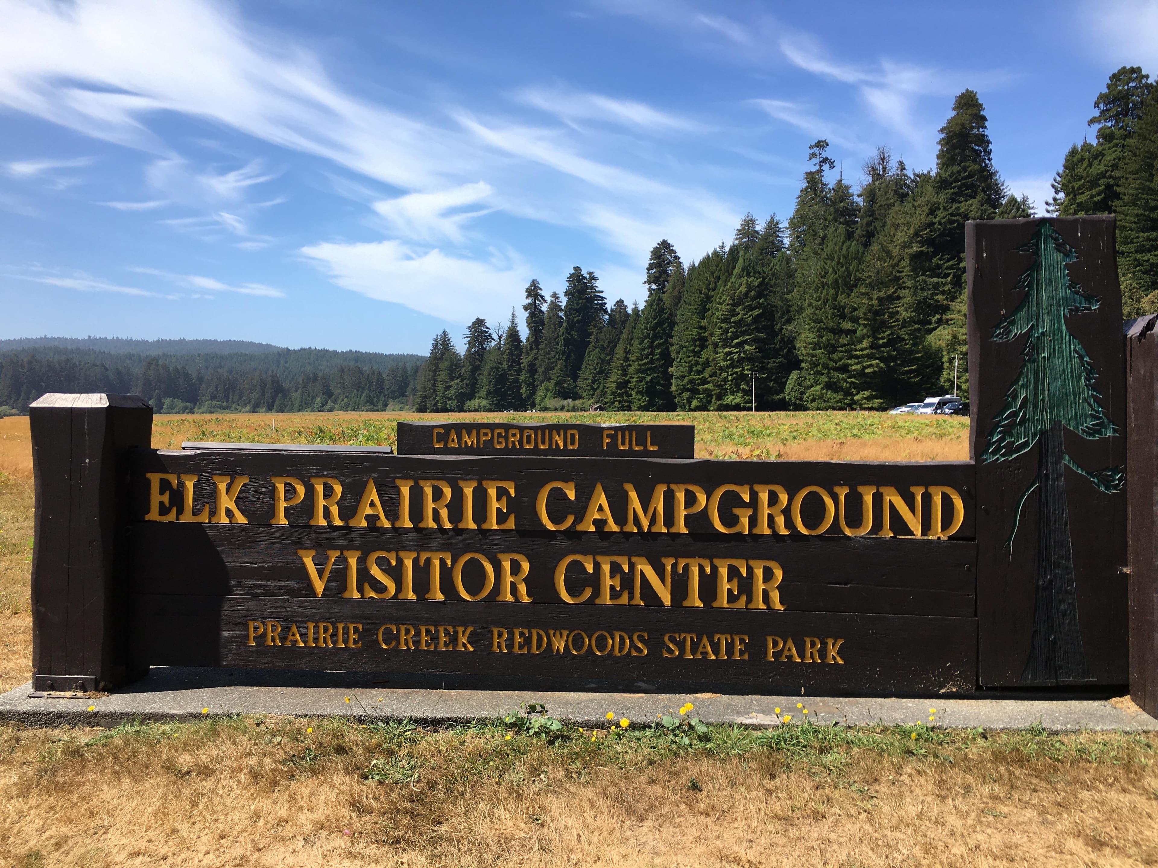 Brown and yellow park sign.