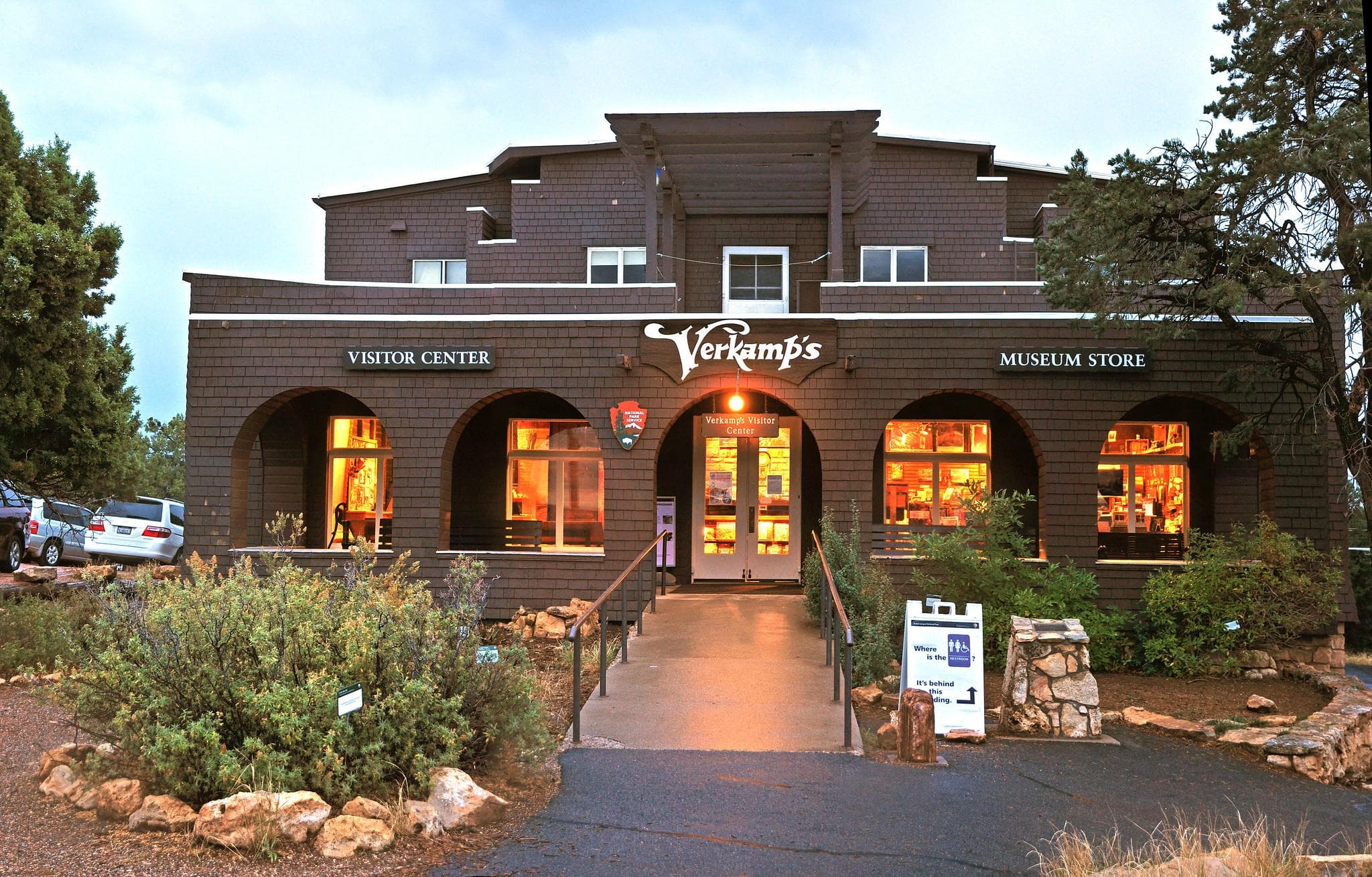 A two-story craftsman style building with the entrance in the center four large window within arches