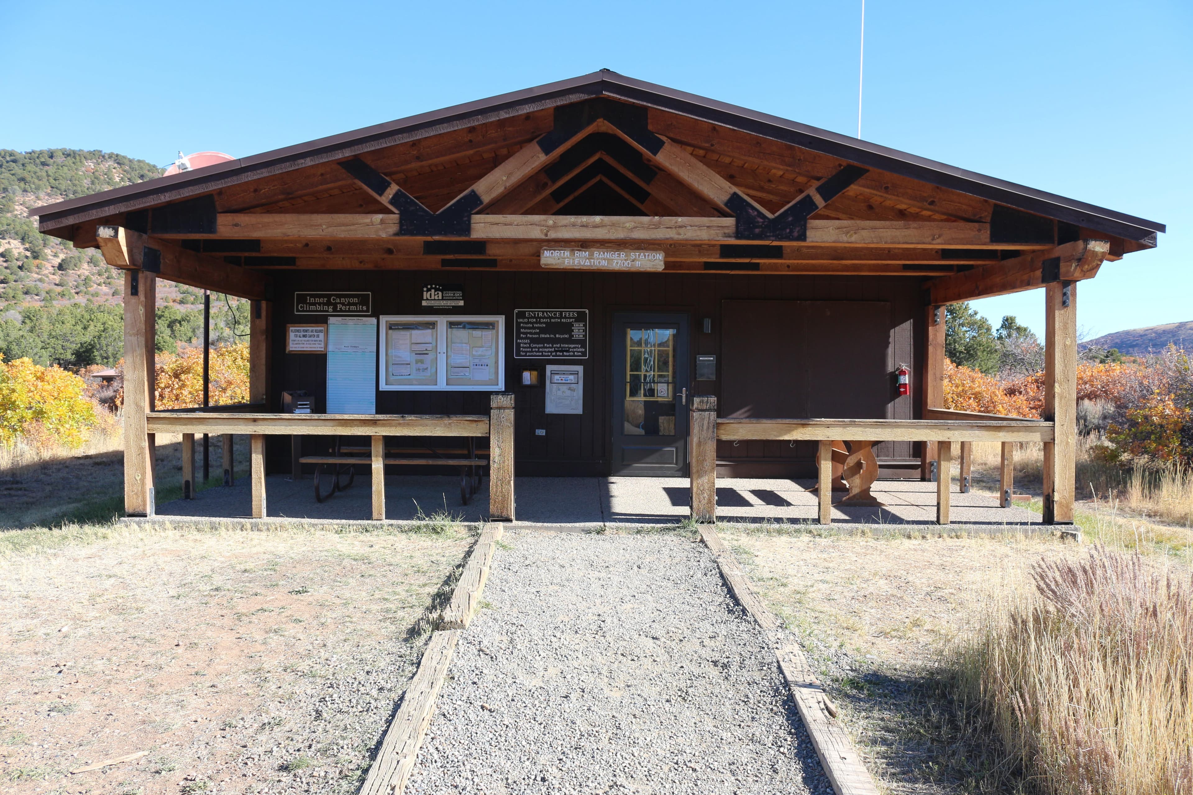The front porch of a wooden ranger station building with information