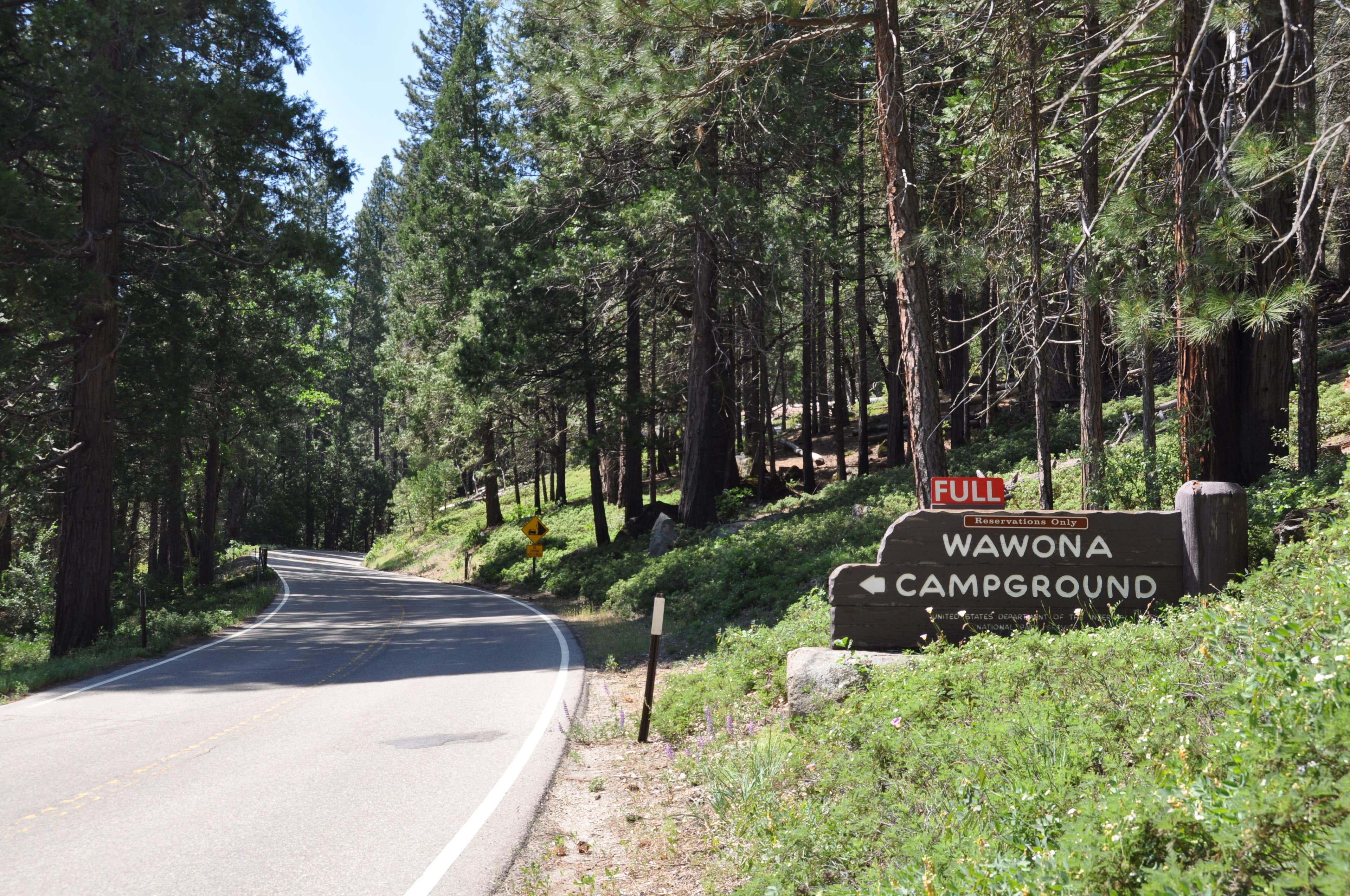 Wooden Wawona Campground sign located along the Wawona Road