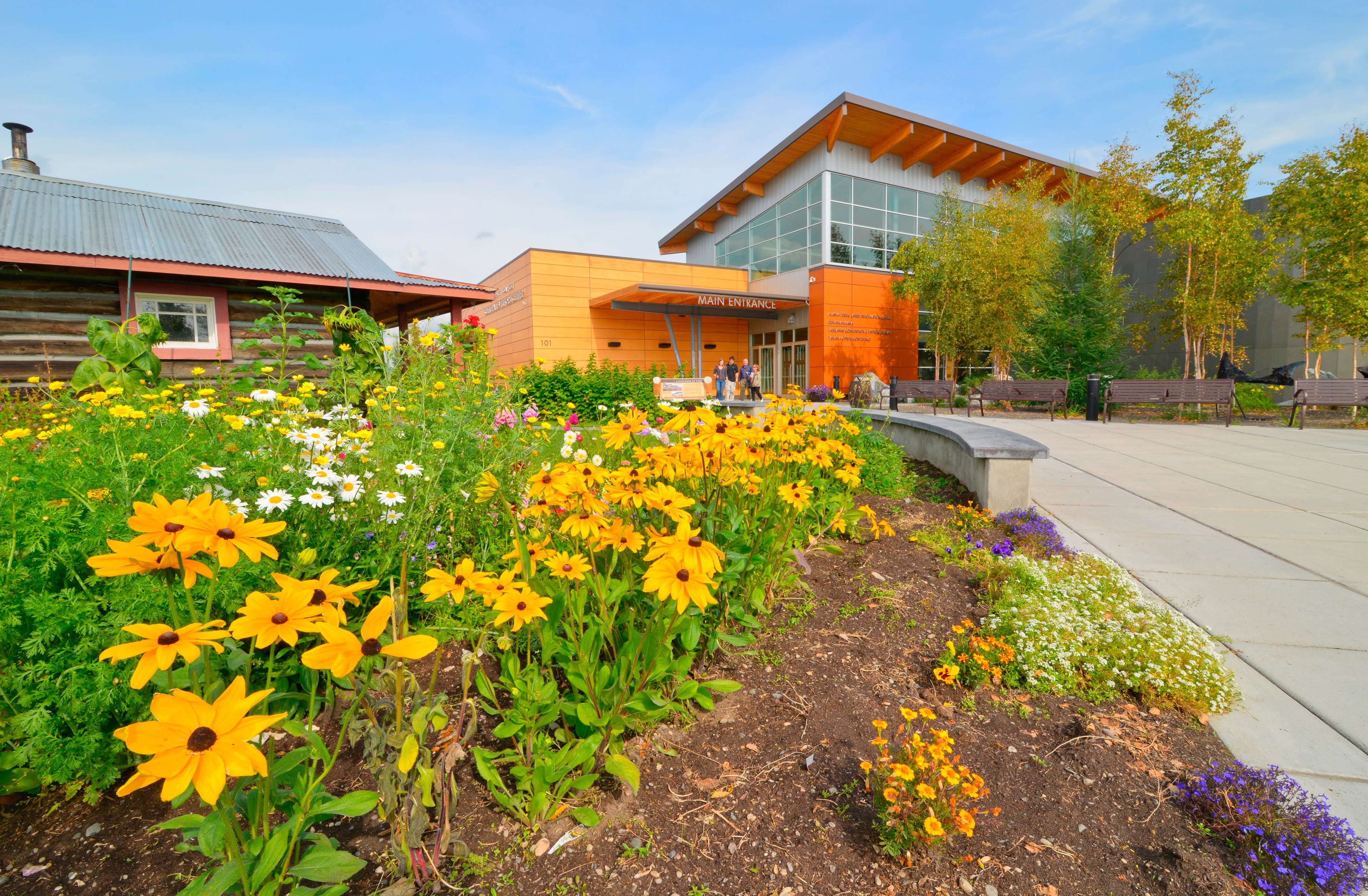 Flowers in front of the entrance to the Morris Thompson Cultural & Visitors Center