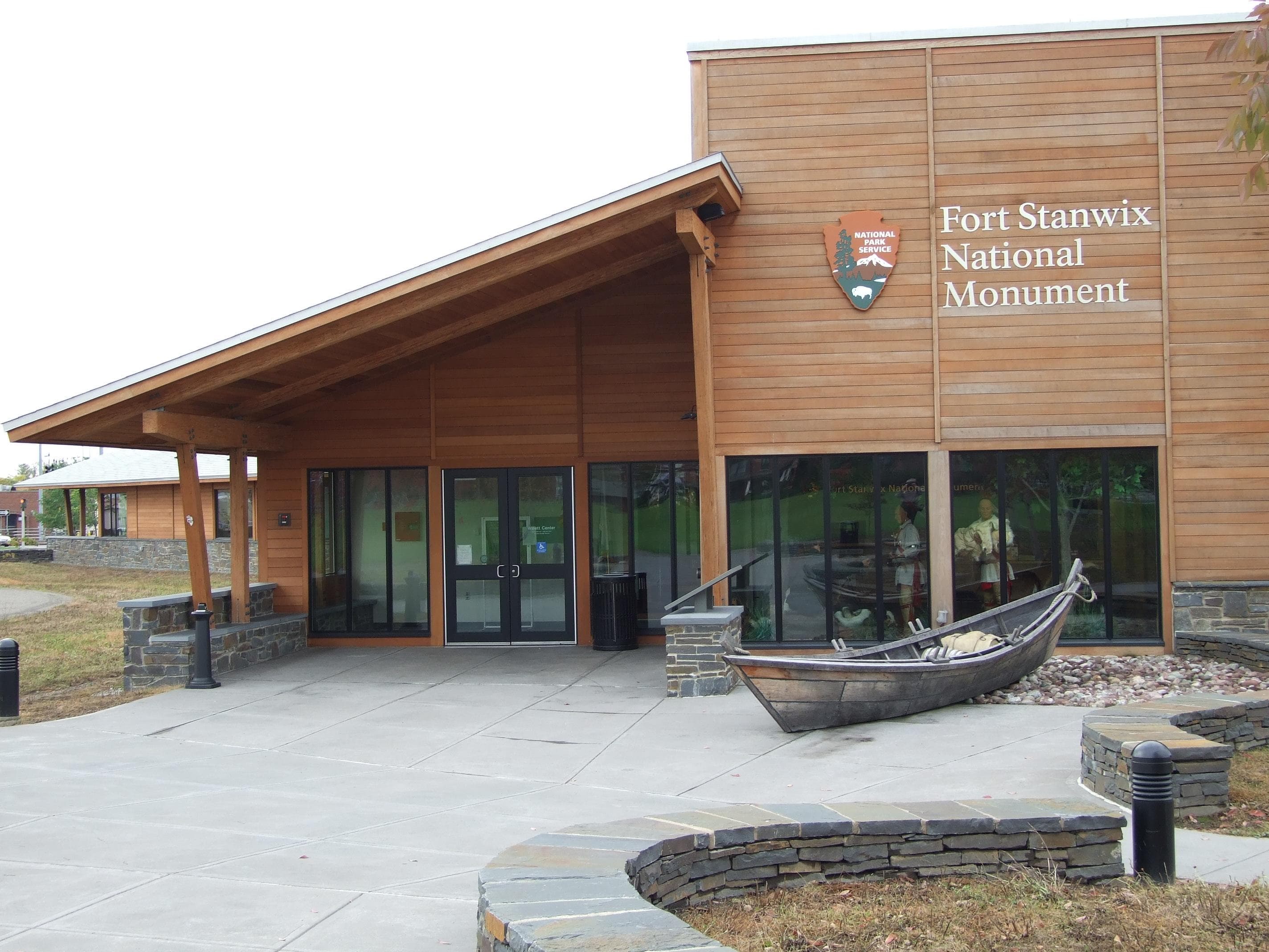 A wooden building with a big National Park Service arrowhead on the side.