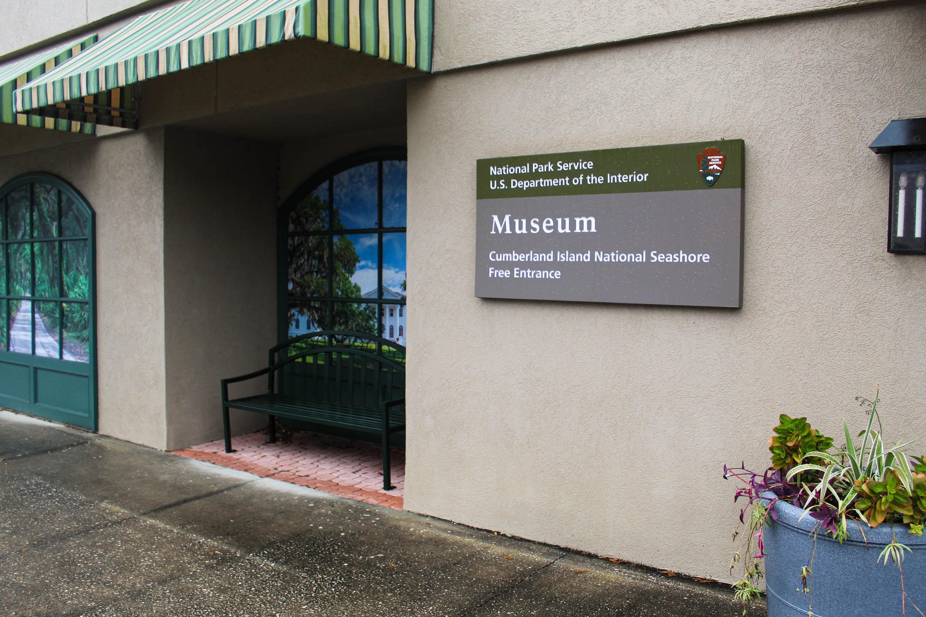 Front of building with museum sign and picture window