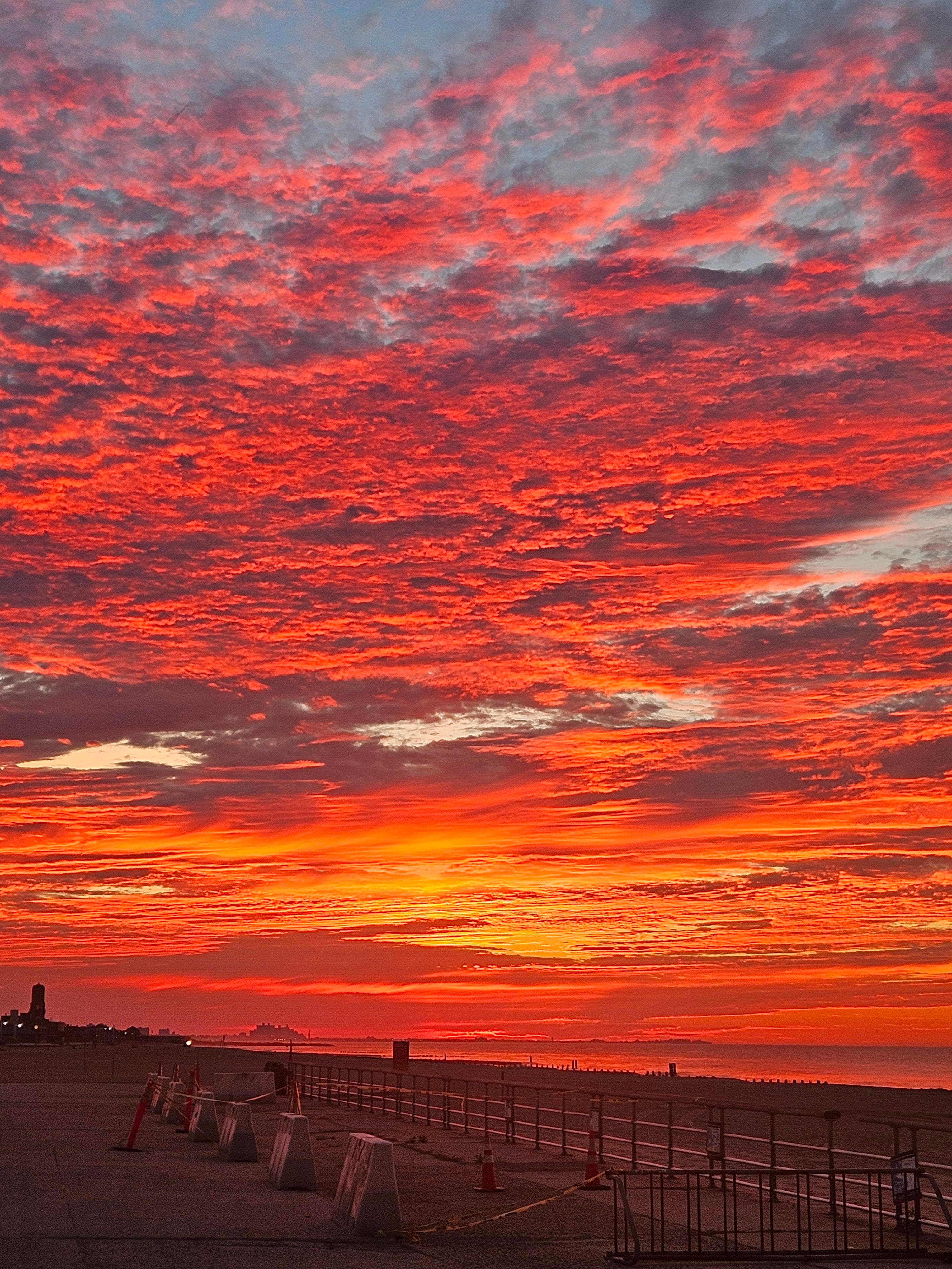 Red pink and orange sky over a body of water