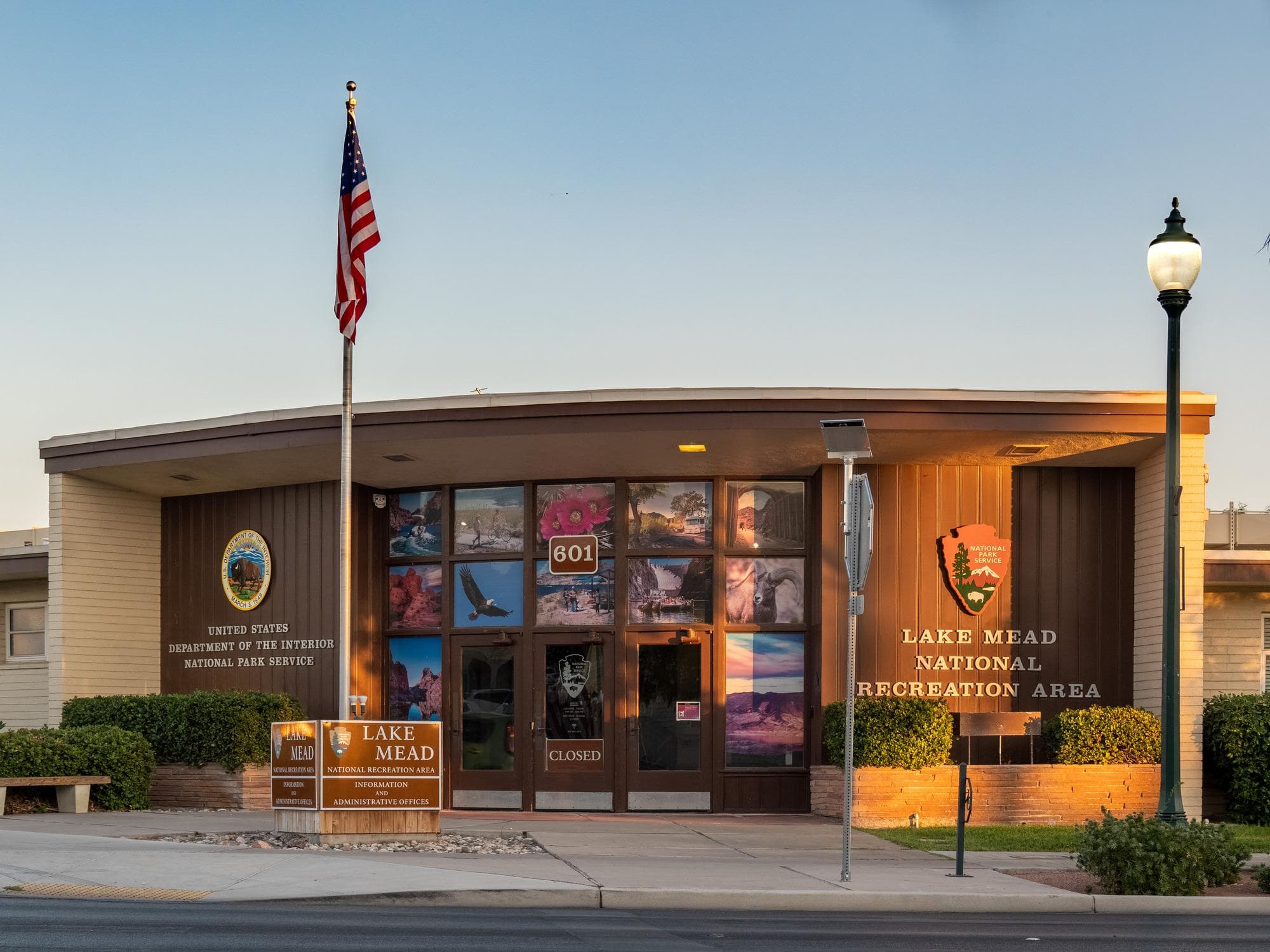 A headquarters building with a flag pole and a large arrowhead.
