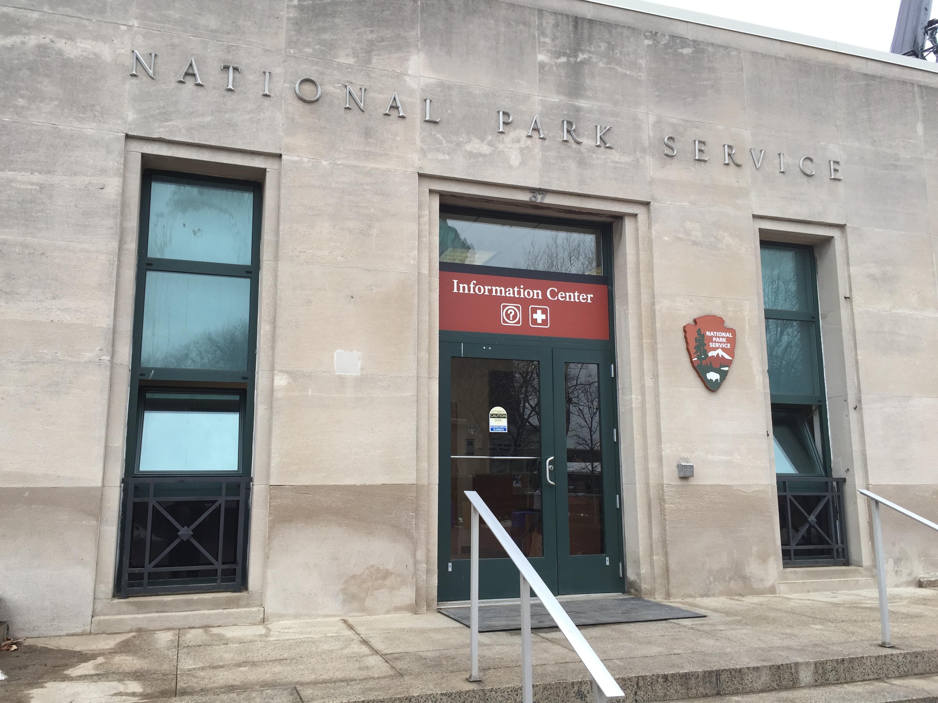 The NPS Info Center has an uneven gray surface with a door at the top of six steps.